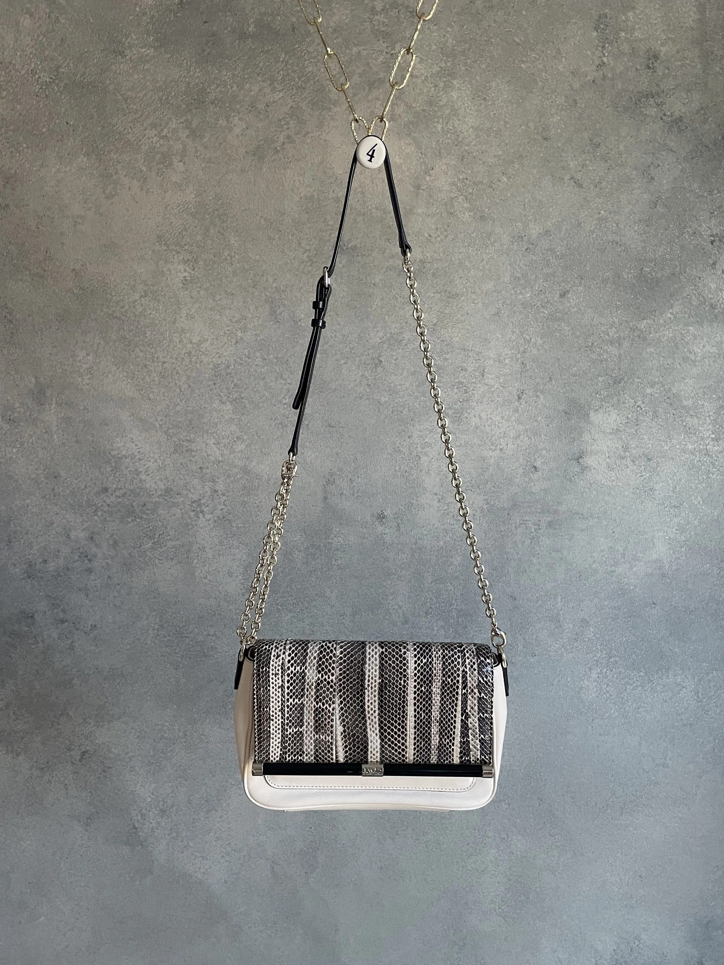 Front view of a never-worn Diane von Furstenberg 440 envelope bag featuring cream leather and snakeskin-print detail with a gold chain strap.