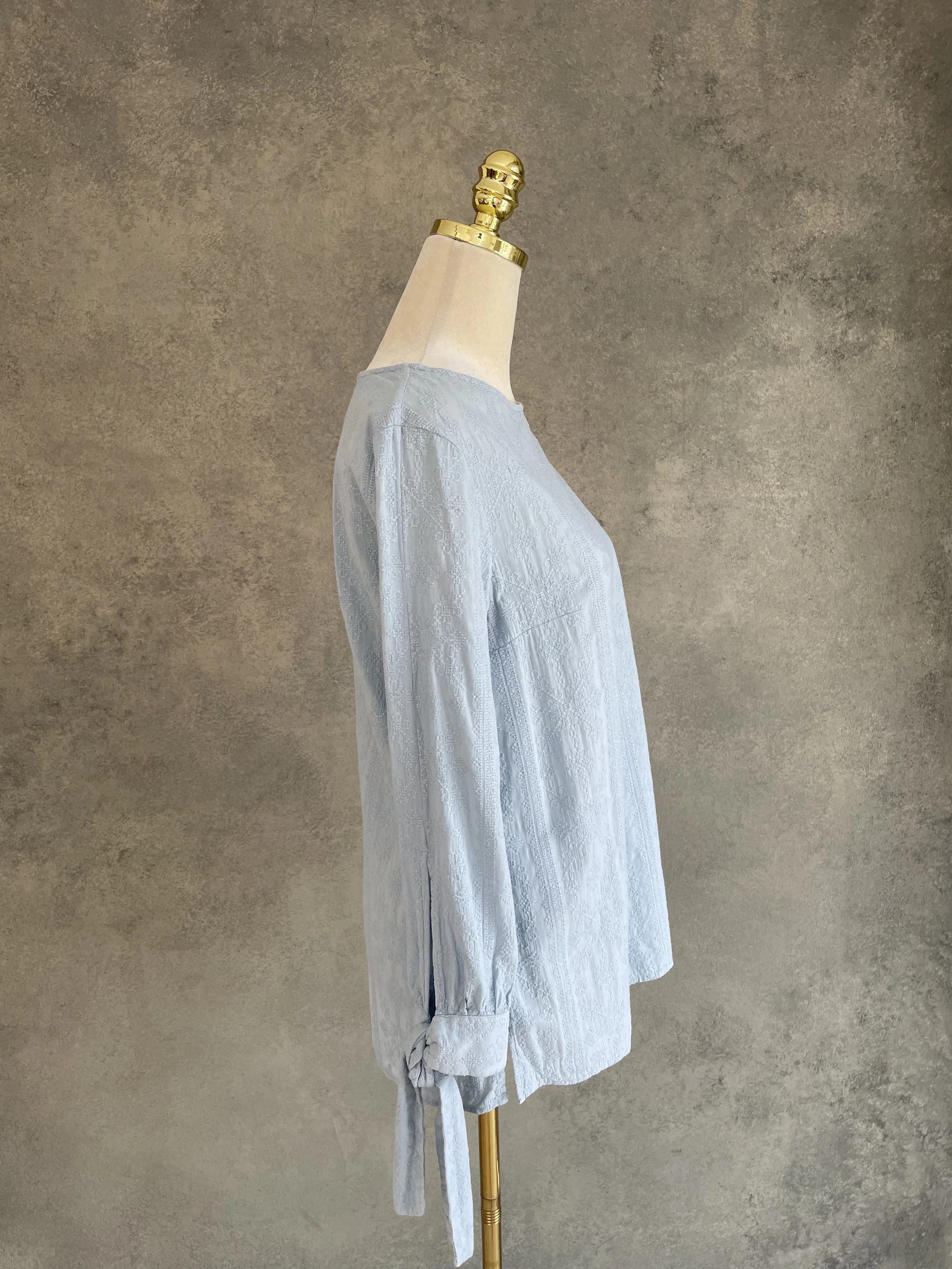 Side profile view of the Dondup blouse, highlighting the textured fabric and sleeve tie."
