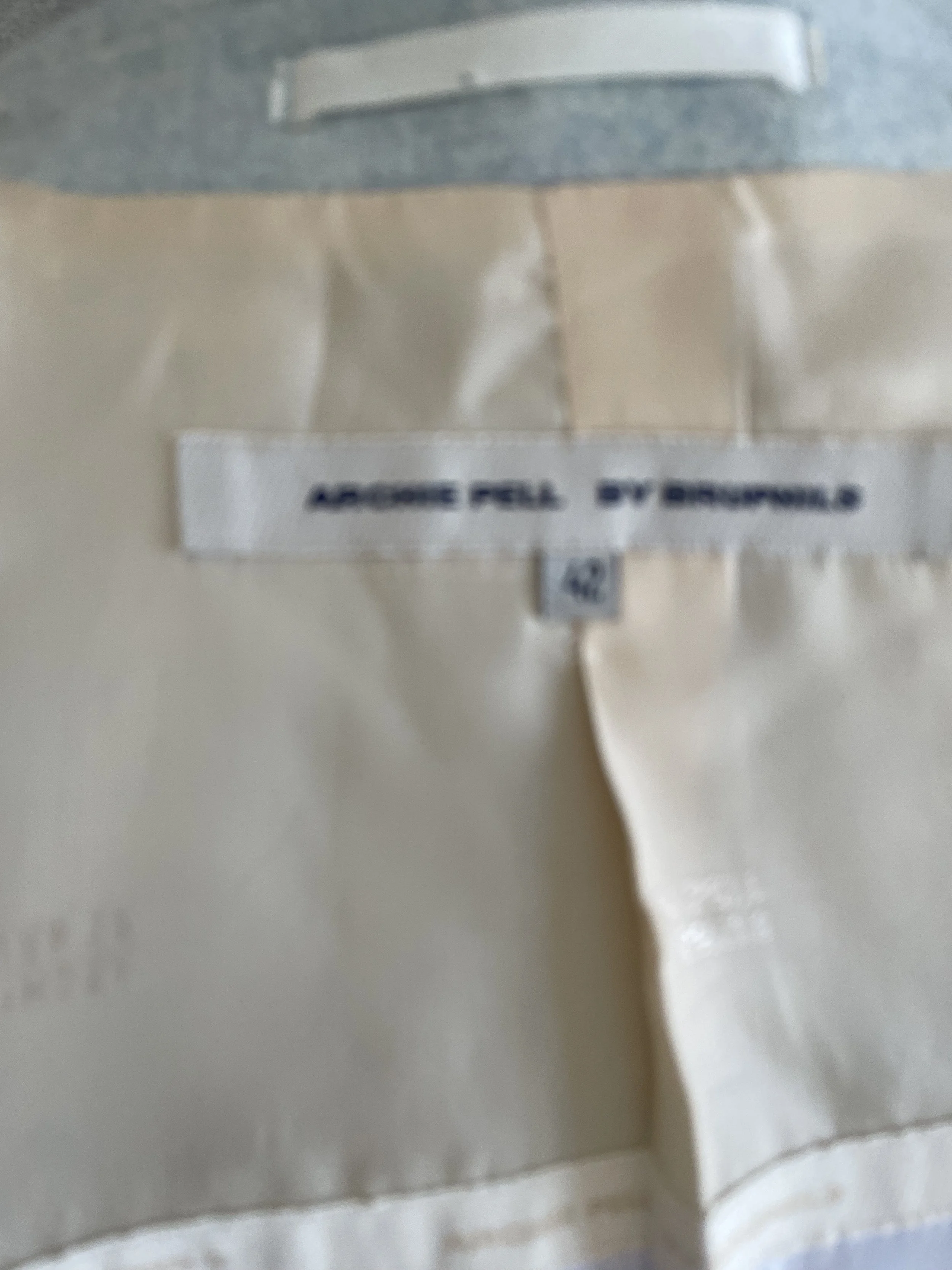 Close-up of the "Archie Pell by Bruphild" brand label stitched inside the blazer.