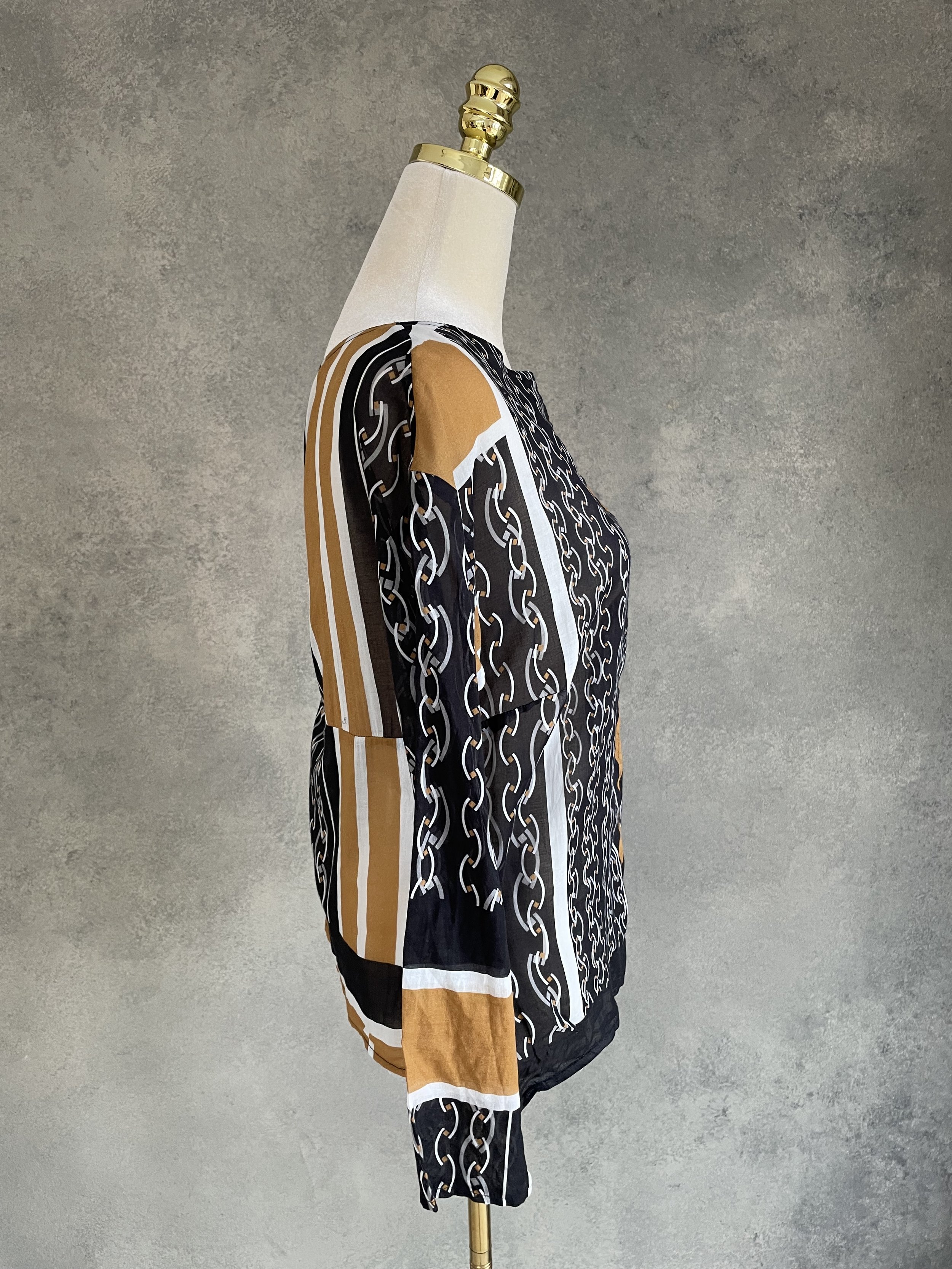 Side view of the HOPE blouse on a mannequin, highlighting the mix of pattern and color blocking.