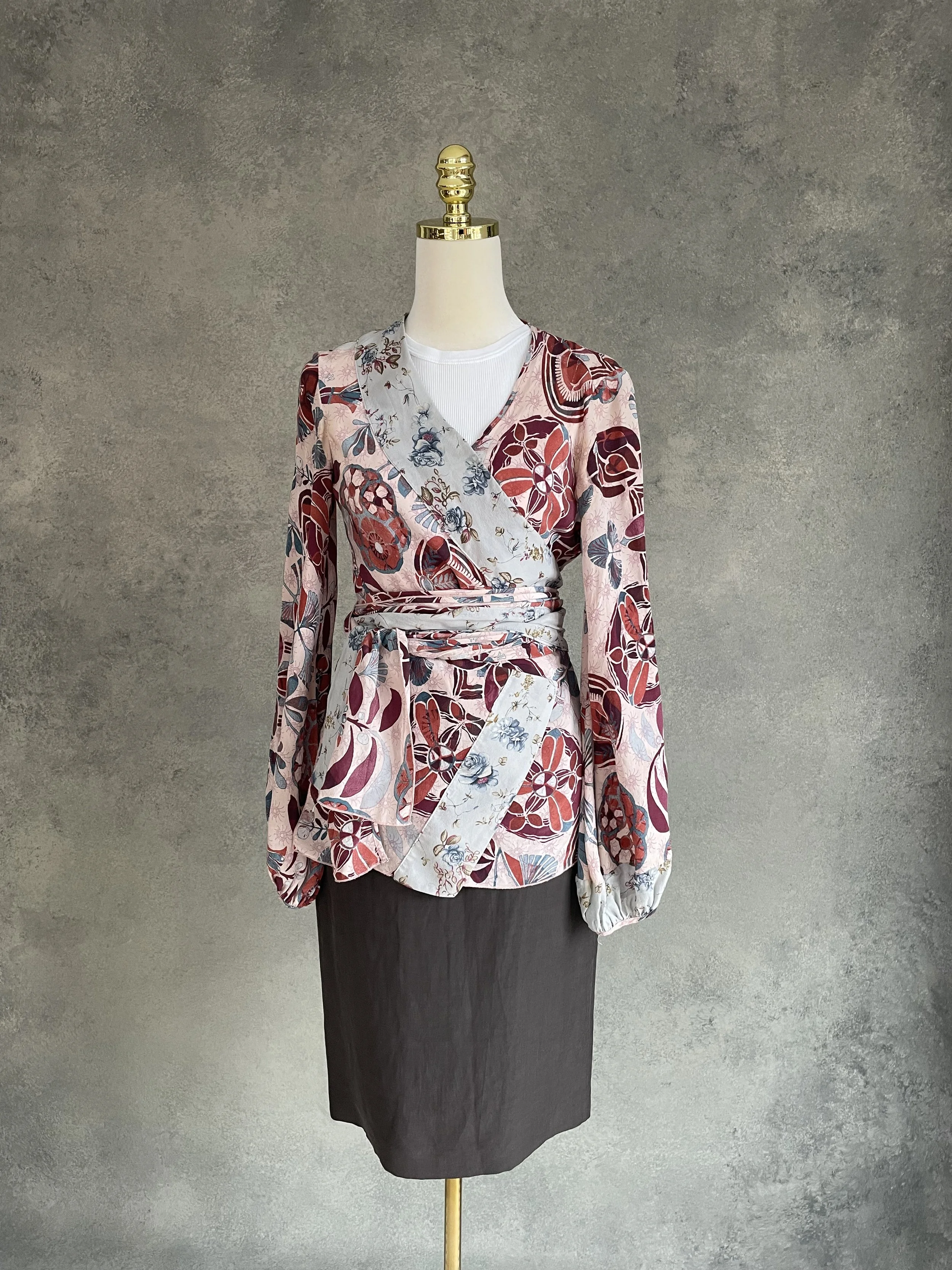 Mannequin wearing the Armani Collezioni brown skirt styled with a Dondup floral-patterned wrap blouse