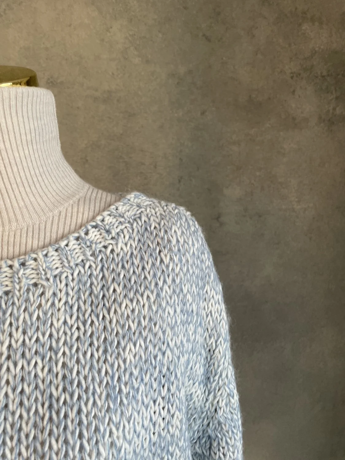 Close-up of the shoulder seam and open-weave knit structure of the Scapa Flow sweater.