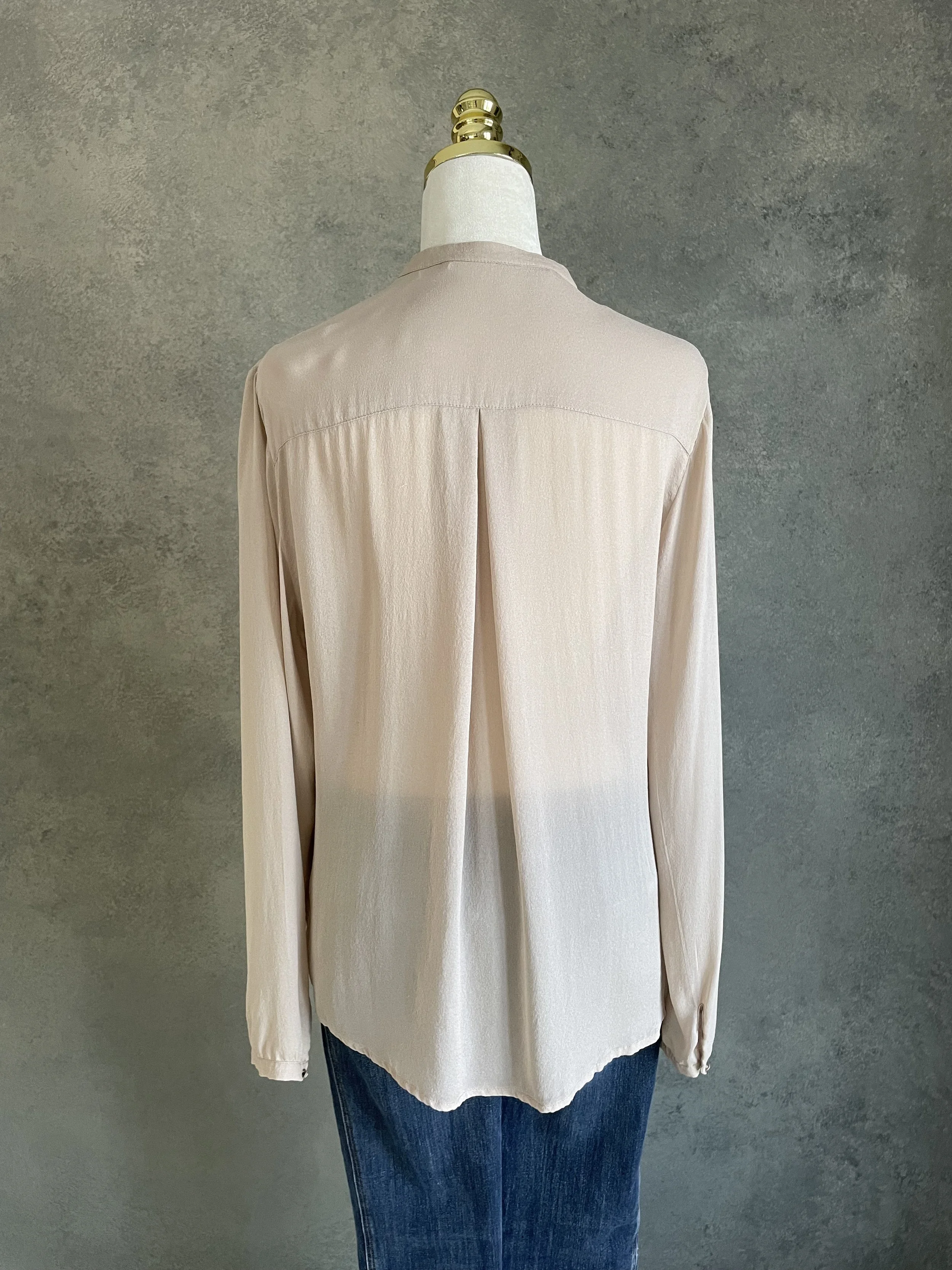 Back shot of the Custommade blouse fabric, emphasizing the smooth, premium texture of the beige silk