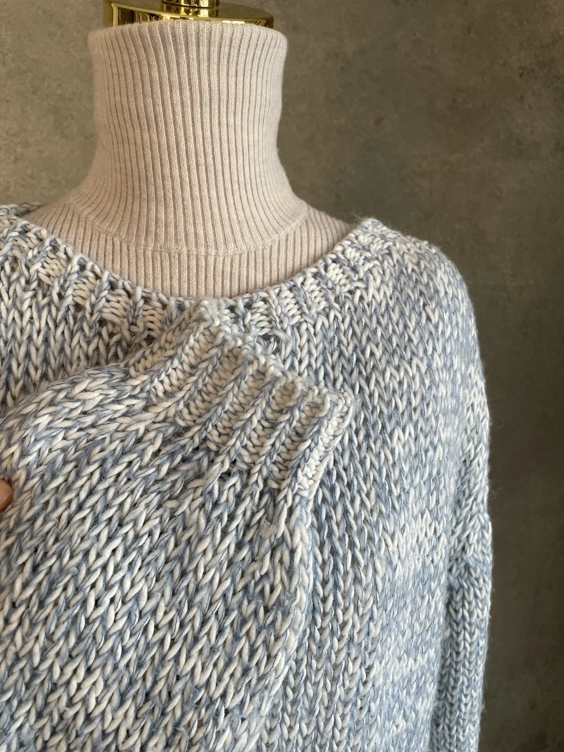 Close-up of the wide boat neckline and heavy textured knit pattern on the Scapa Flow sweater.