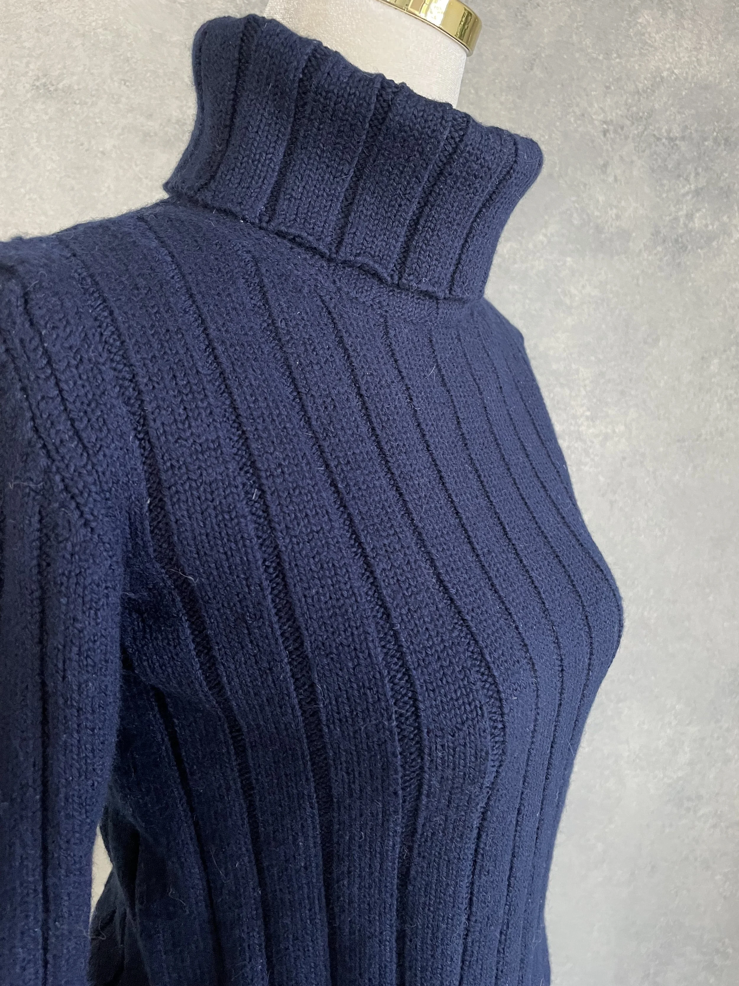 Detail shot of the Hugo Boss navy wool turtleneck shoulder, highlighting the clean, professional tailoring