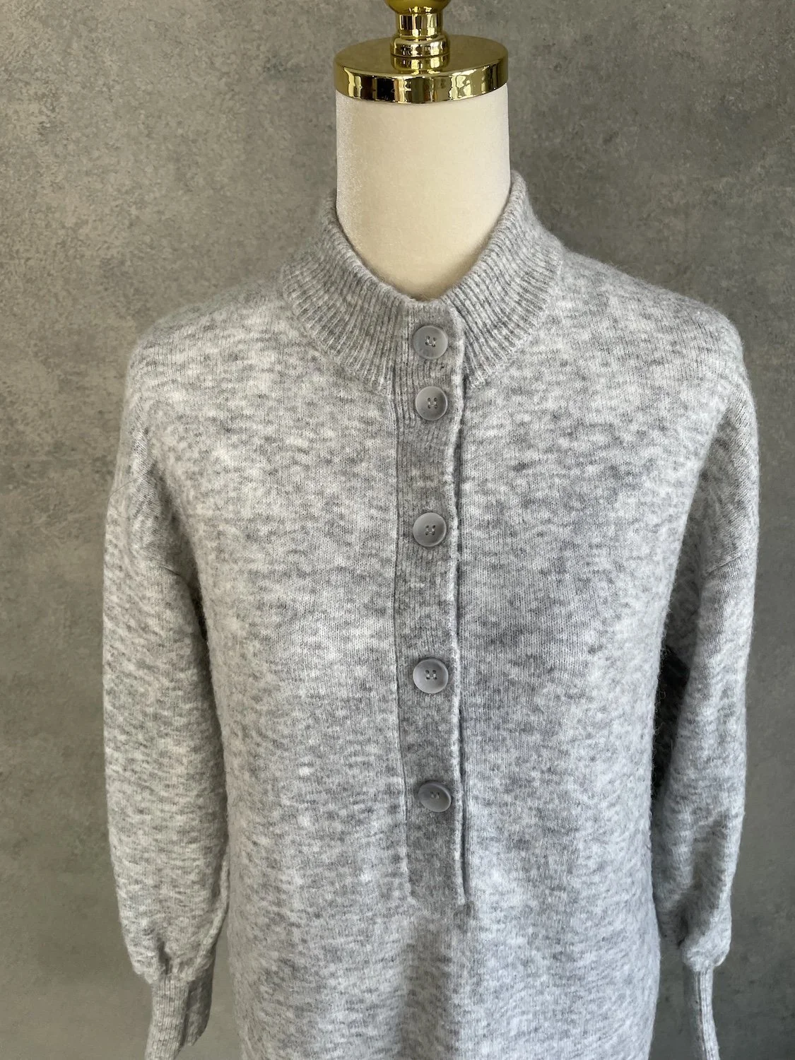 Xandres mock neck and button placket close-up on knit dress