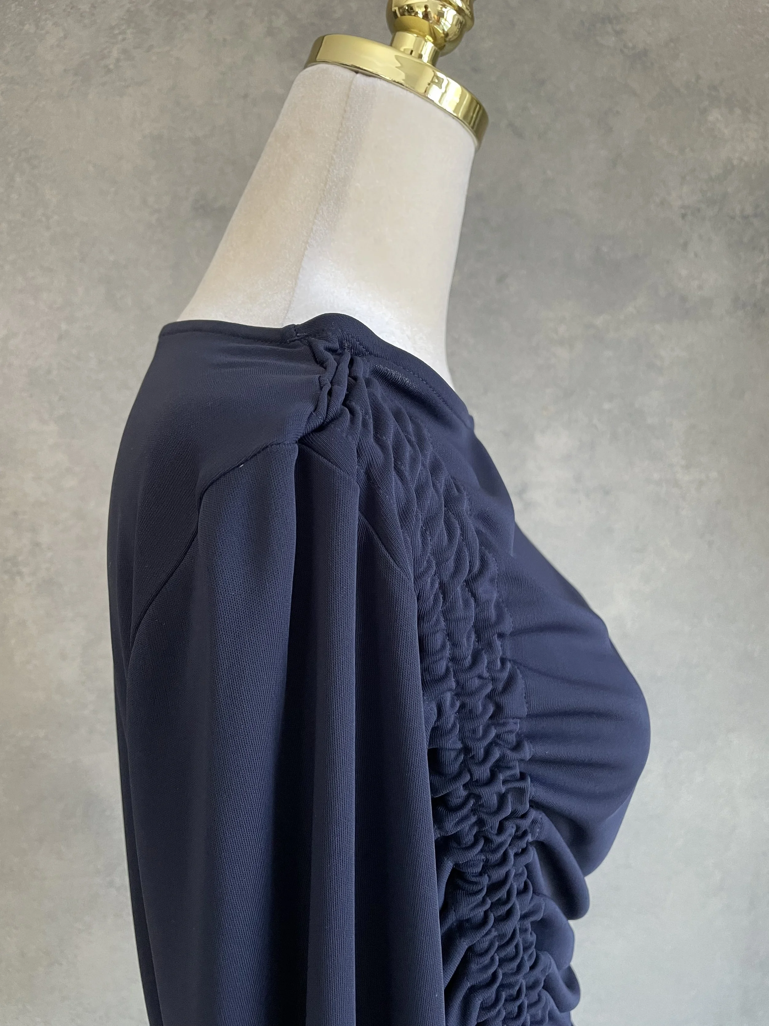 Detailed view of the shoulder and side-ruching construction on the BLANCHE navy top.