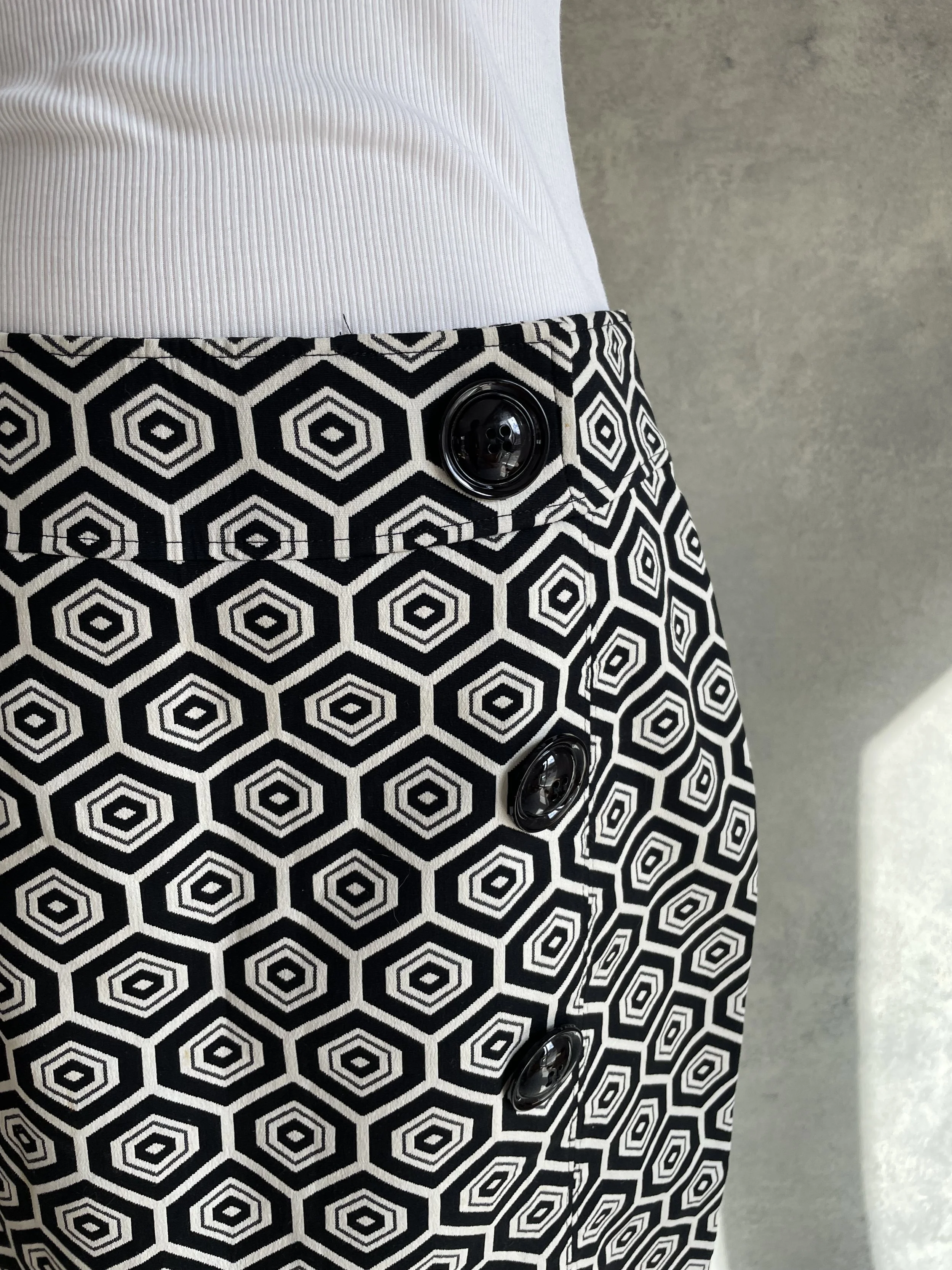 Close-up of the three-button detail on the Caroline Biss black and white skirt.