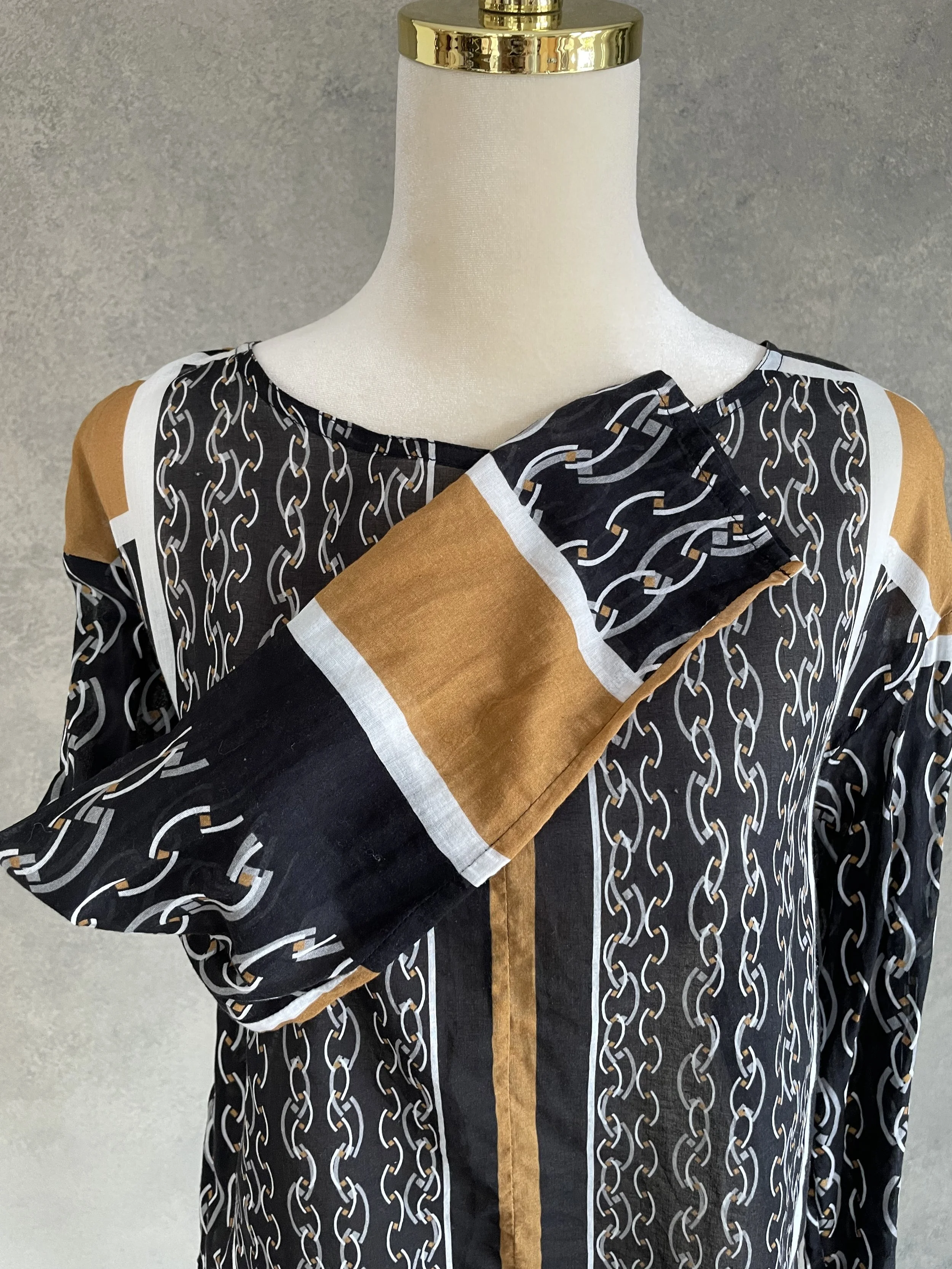 Close-up showing the chain pattern and striped side panels of the HOPE blouse.