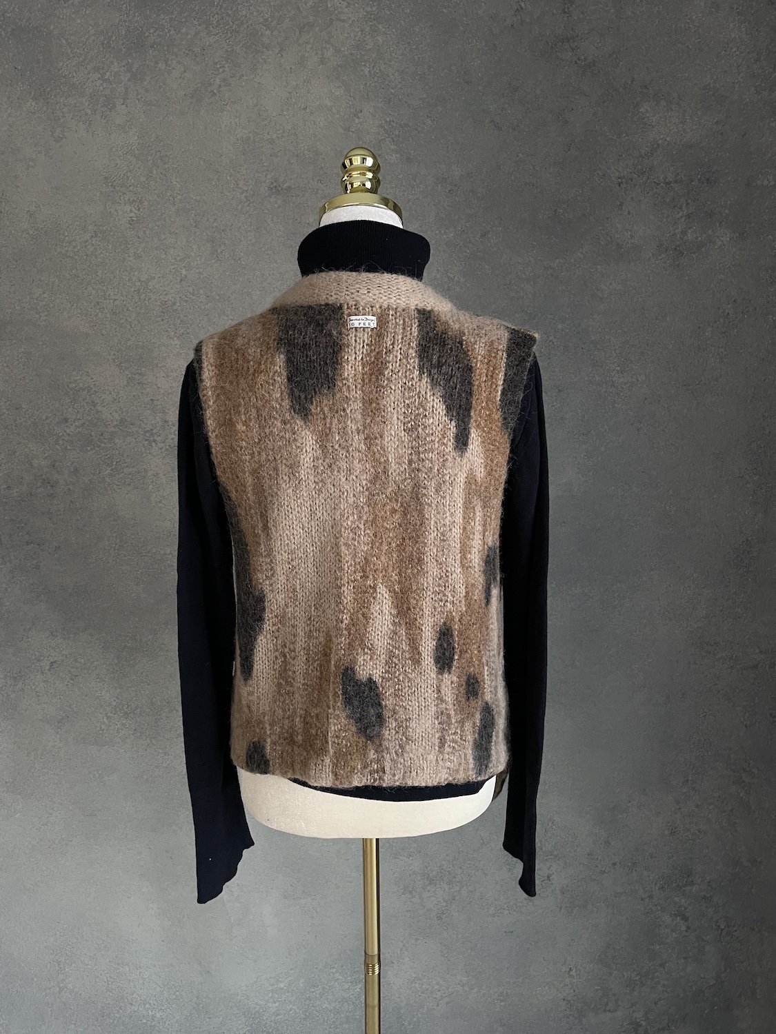 Back view of 10 Feet three-tone sleeveless knit vest on mannequin