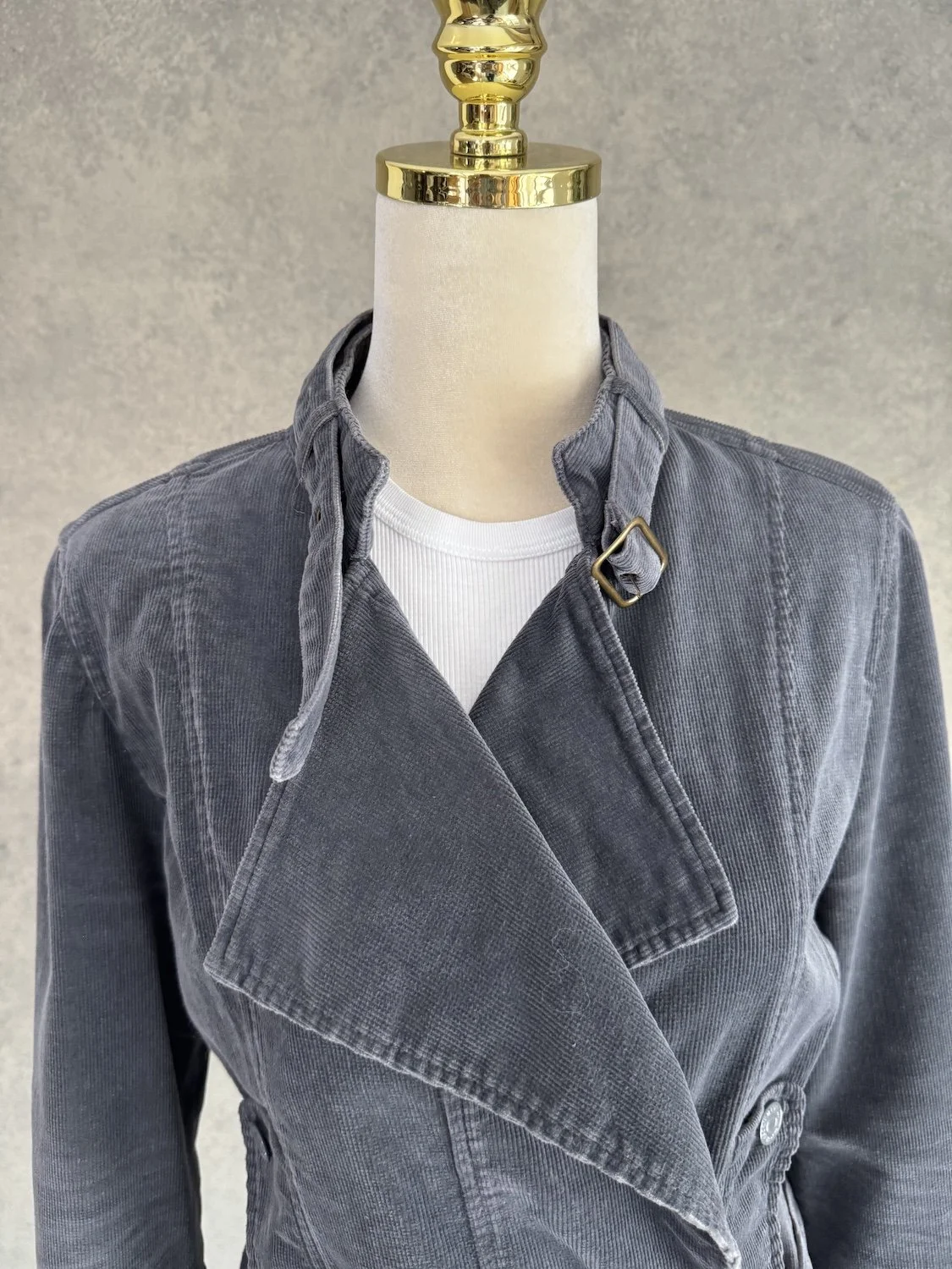 Detailed front view of the asymmetric lapel and collar strap of the Essentiel Antwerp cord jacket.