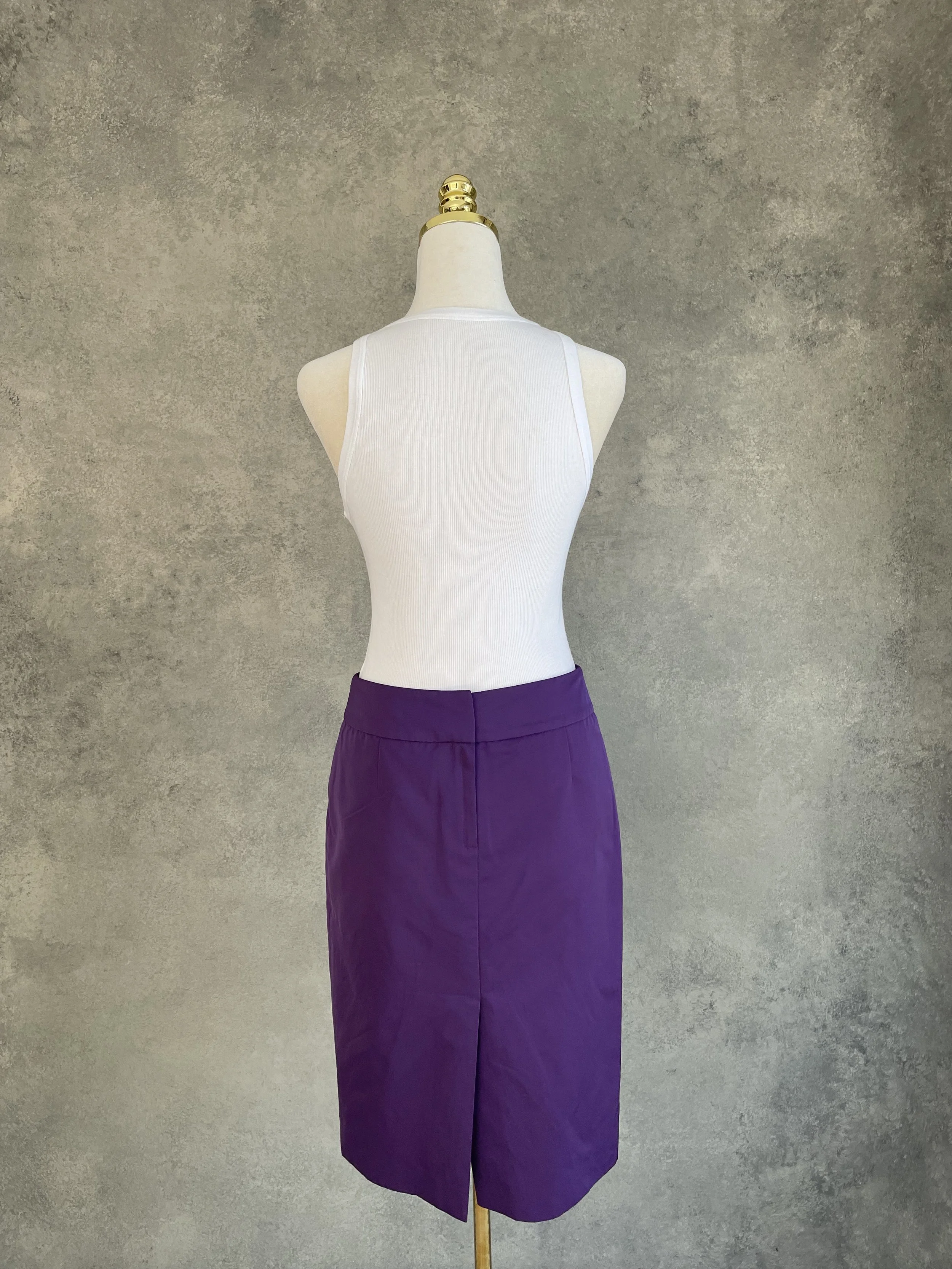 Back view of a purple HUGO BOSS pencil skirt featuring a subtle central vent.
