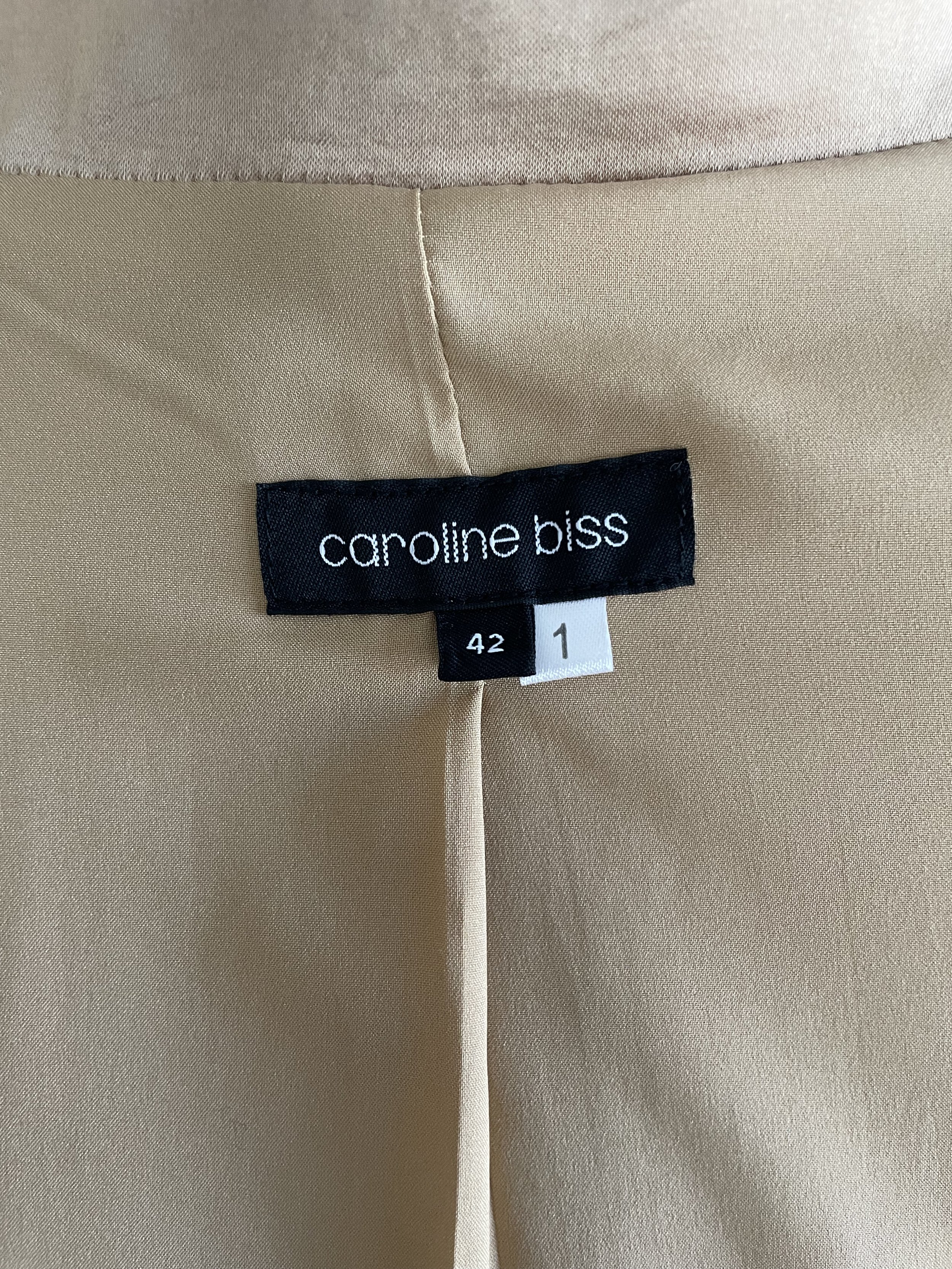 Inside garment tag showing the brand "Caroline Biss" and size "42".