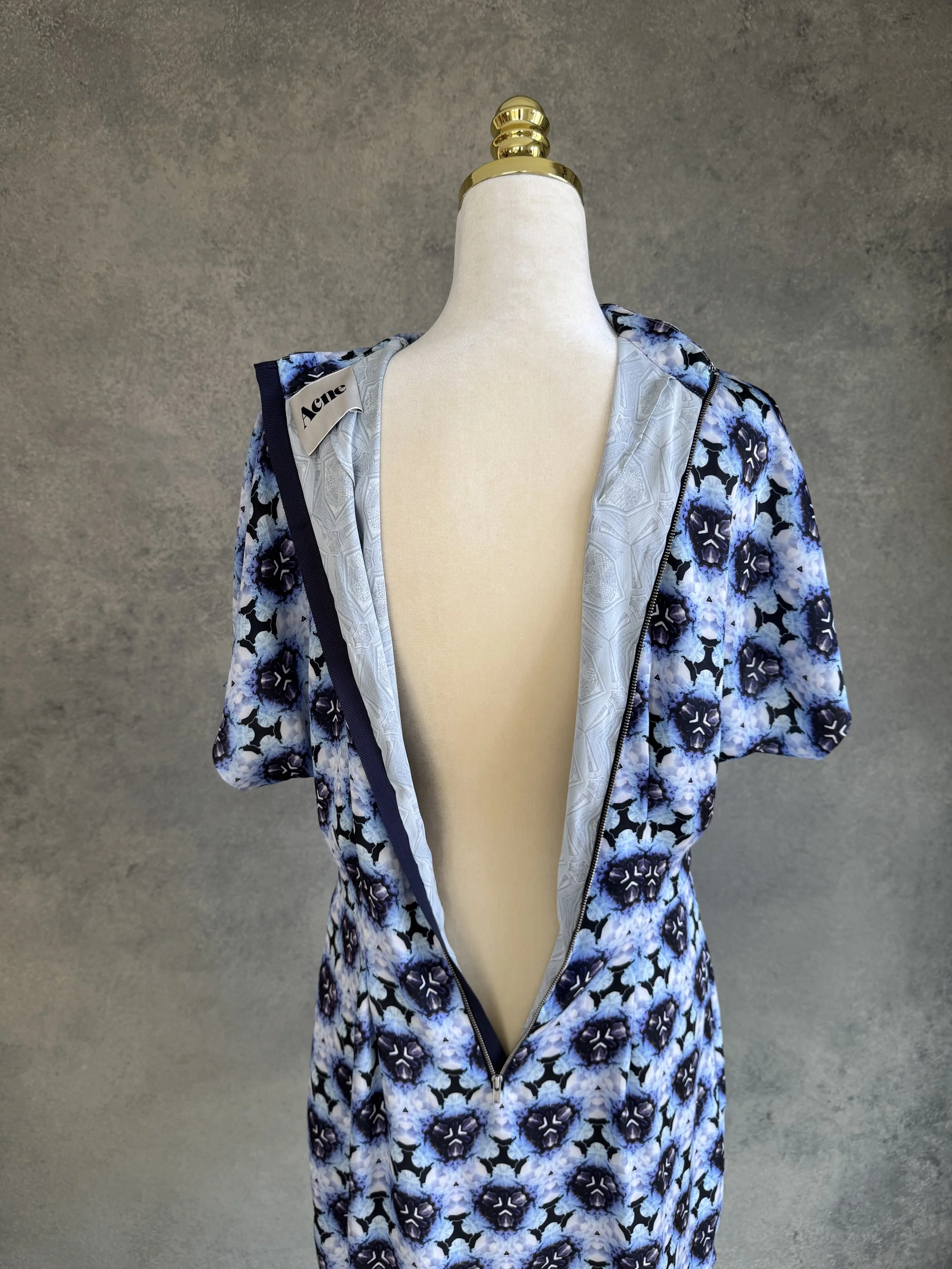 Back view of the dress, displaying the full-length metal zipper closure along the spine.