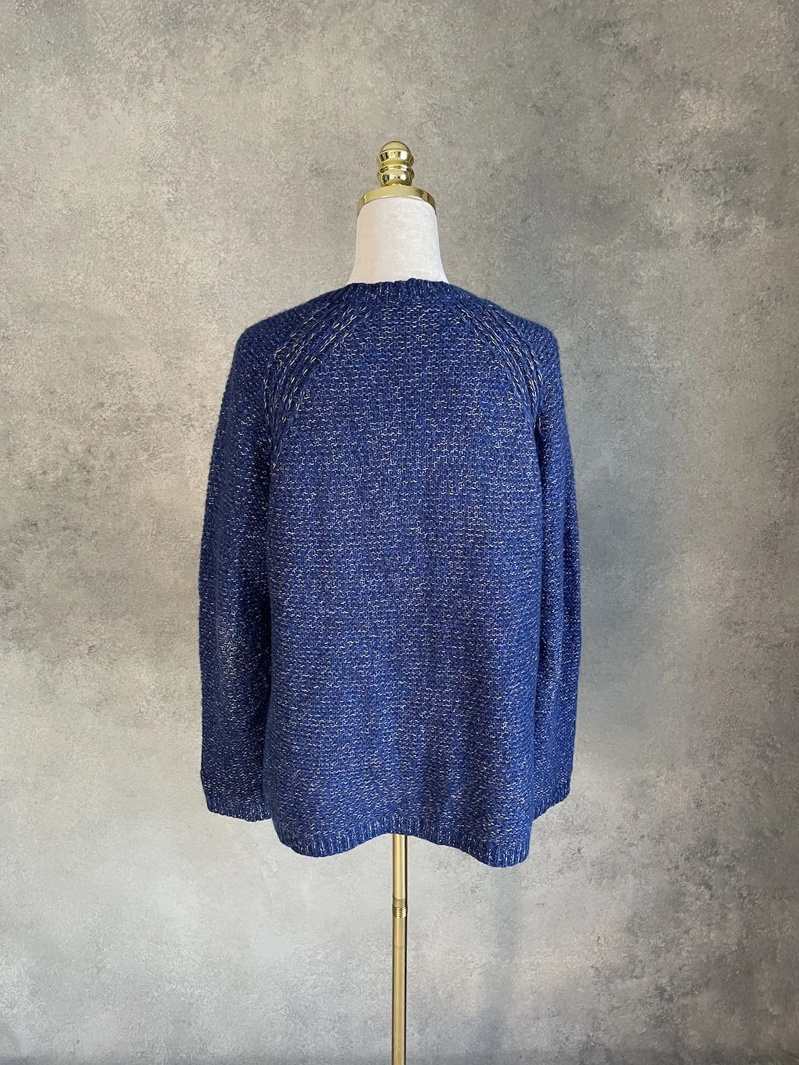 Back view of the Xandres blue knit cardigan highlighting the clean silhouette and shoulder construction.