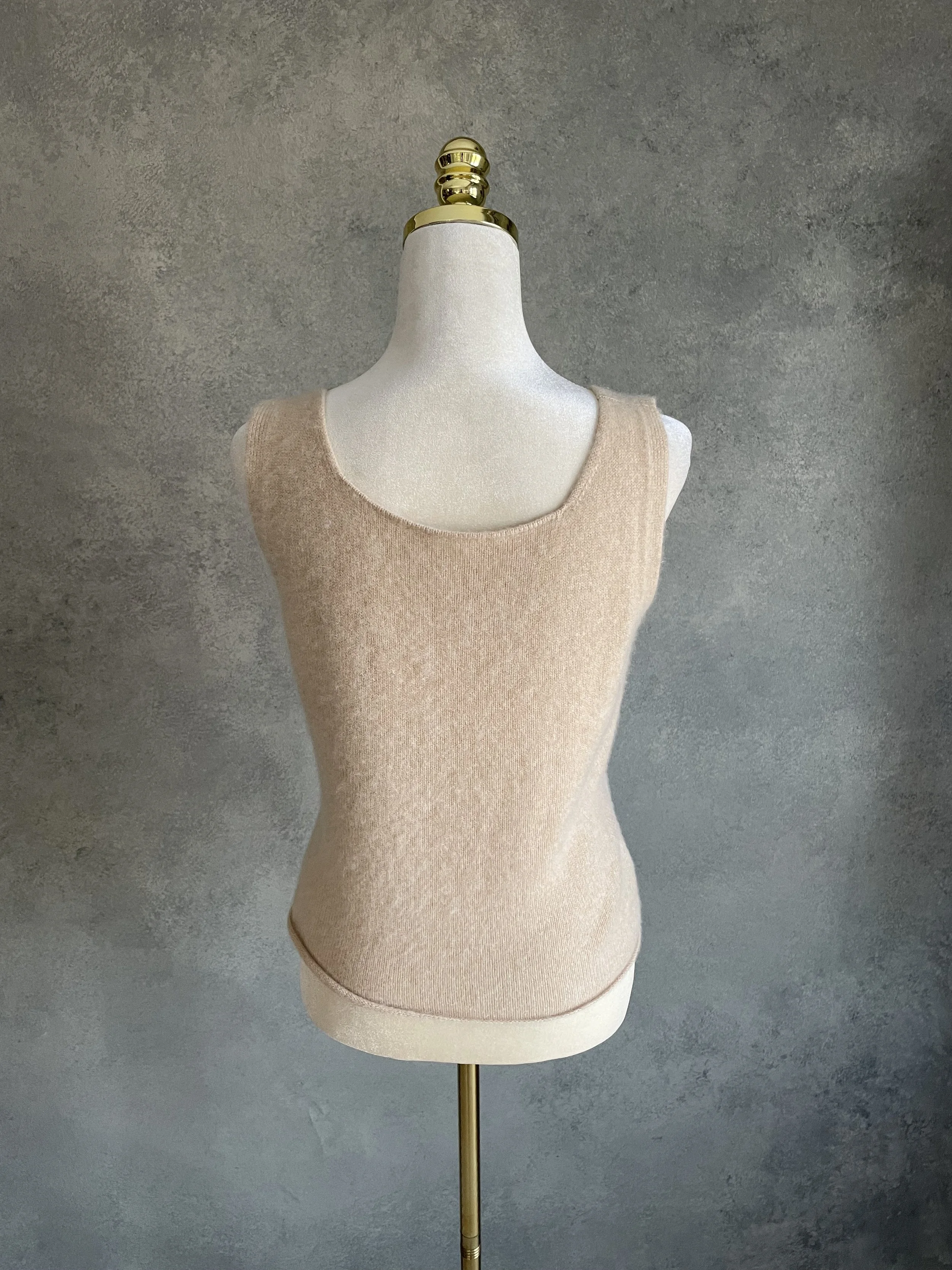 Back view of the beige cashmere tank top, demonstrating the clean, minimalist lines