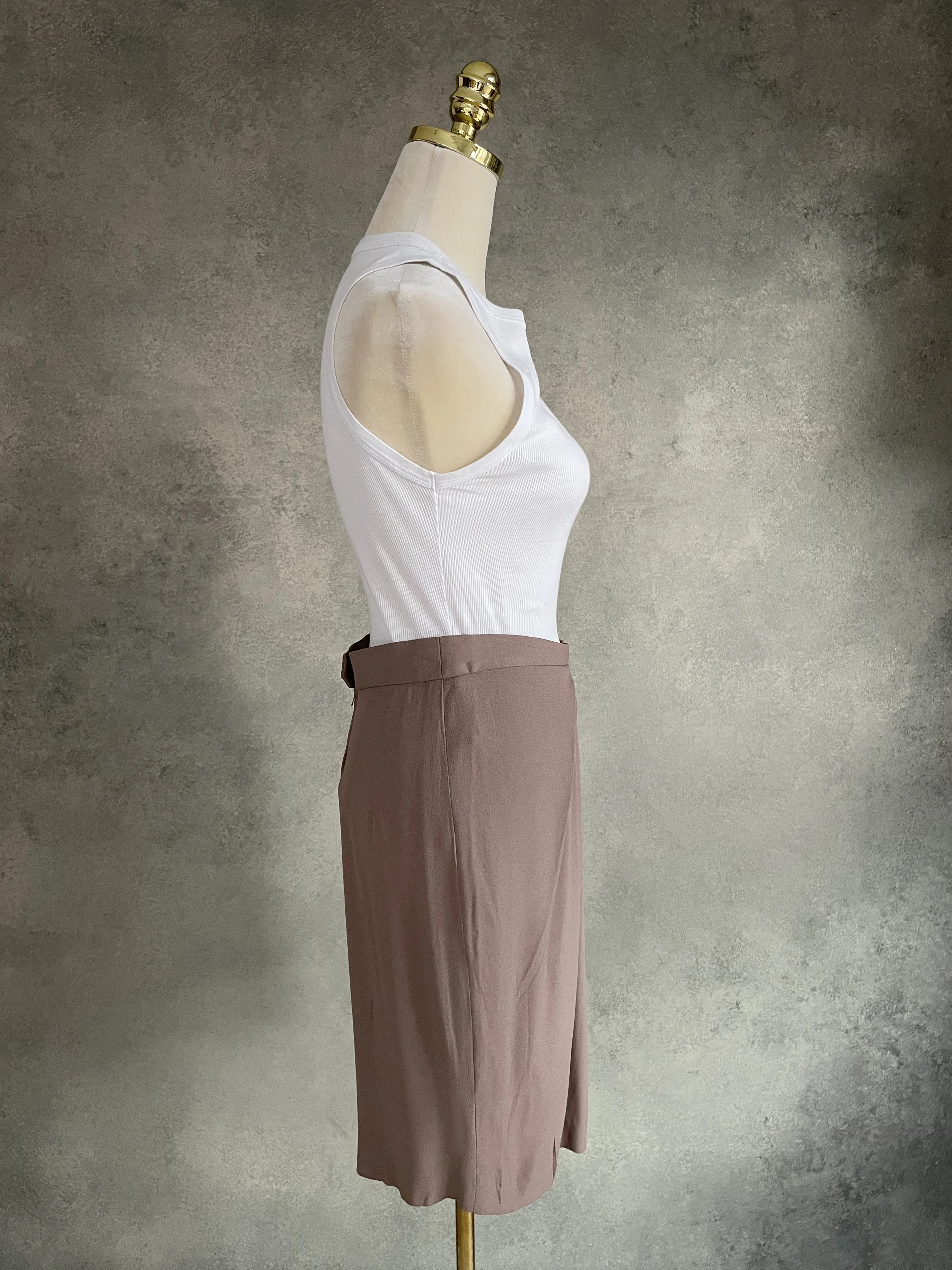 Side profile view of Natan beige pleated skirt showing silhouette and drape.