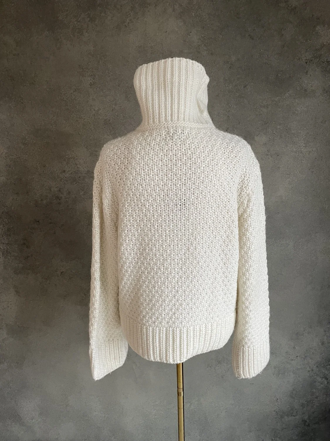 Full back view of the textured basketweave cream sweater.