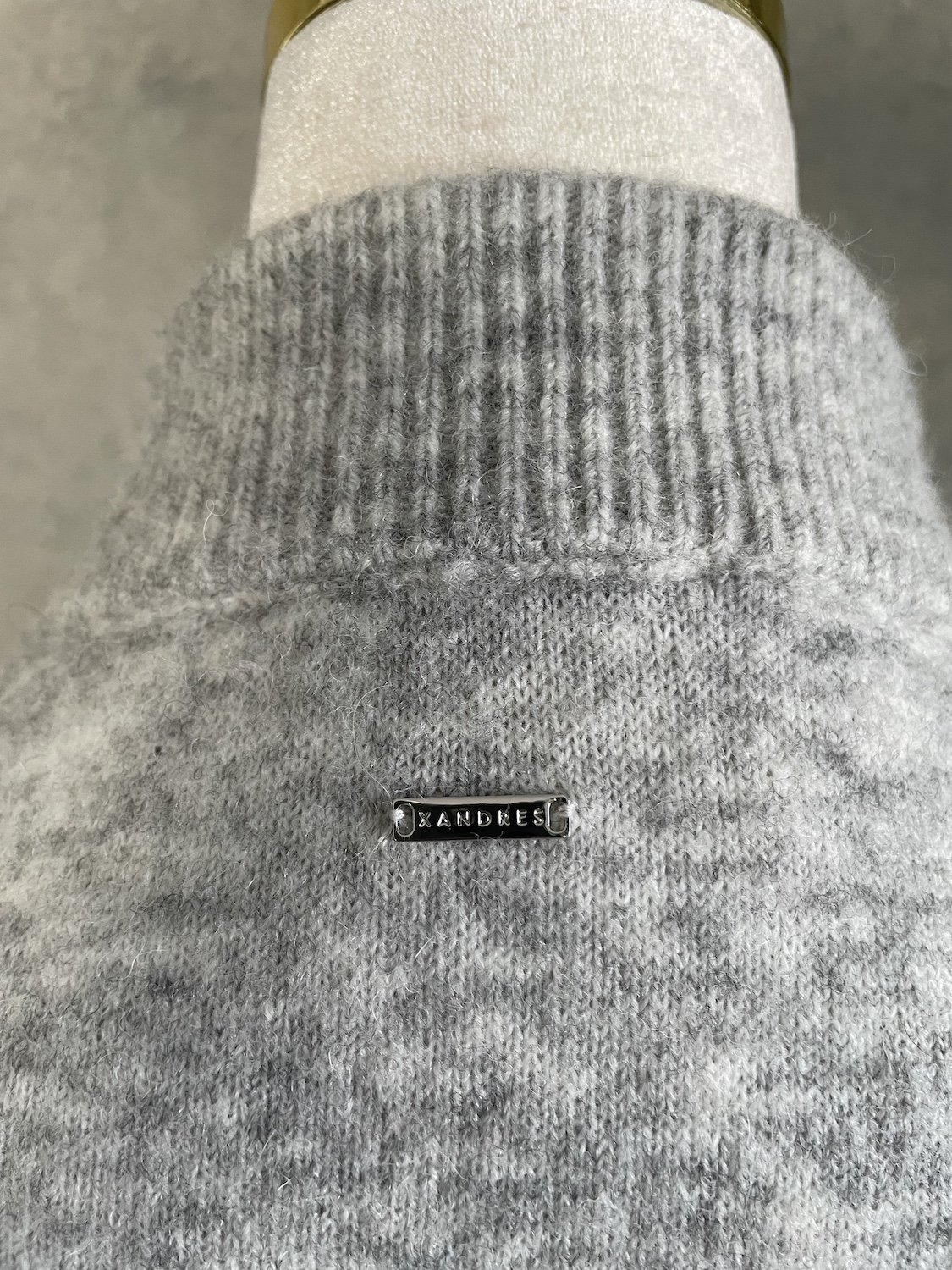 Xandres small metallic logo plaque detail at upper back neck