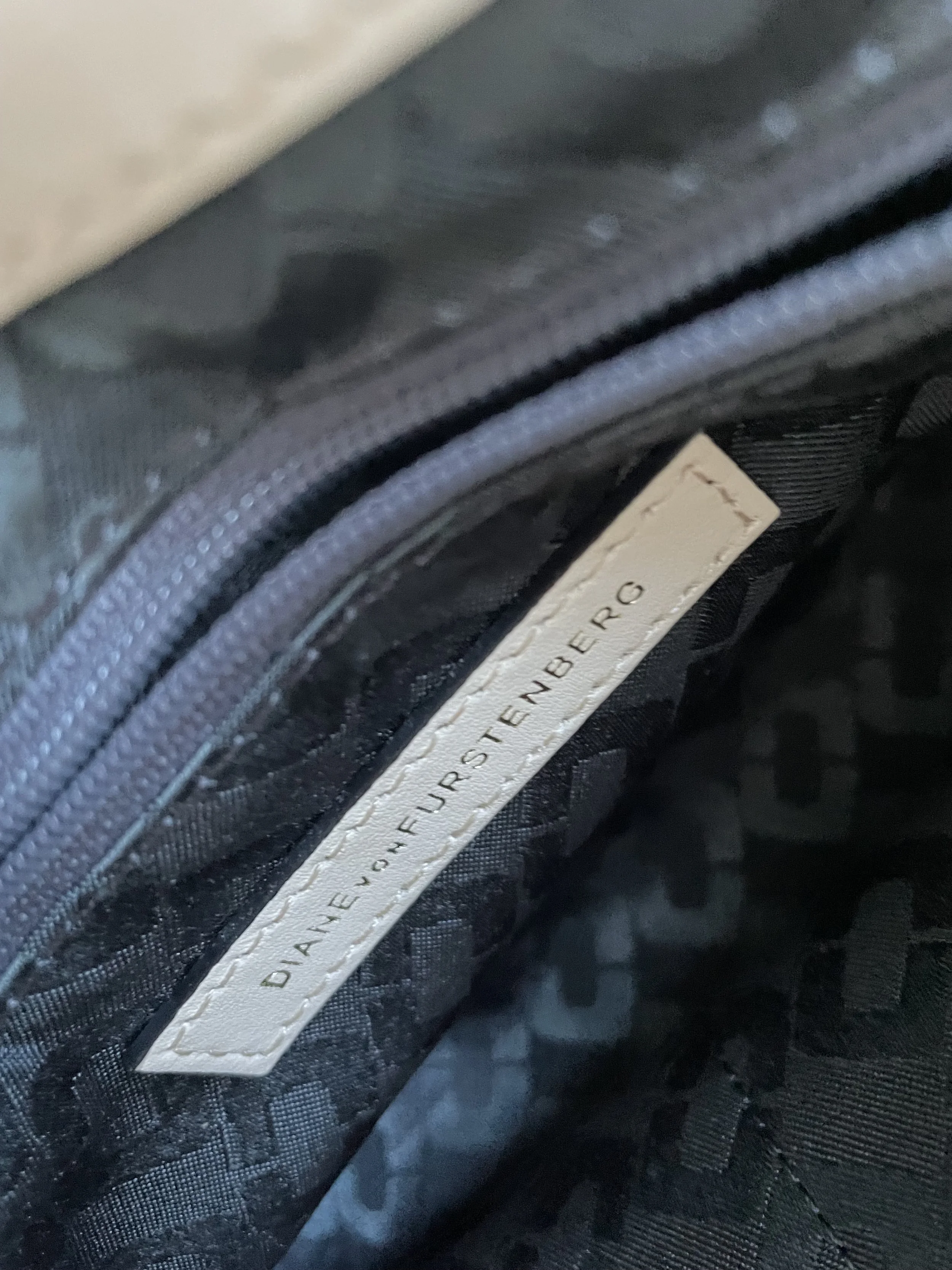 Interior view of the DVF 440 bag showing the "DIANE VON FURSTENBERG" brand label inside the lined compartment.