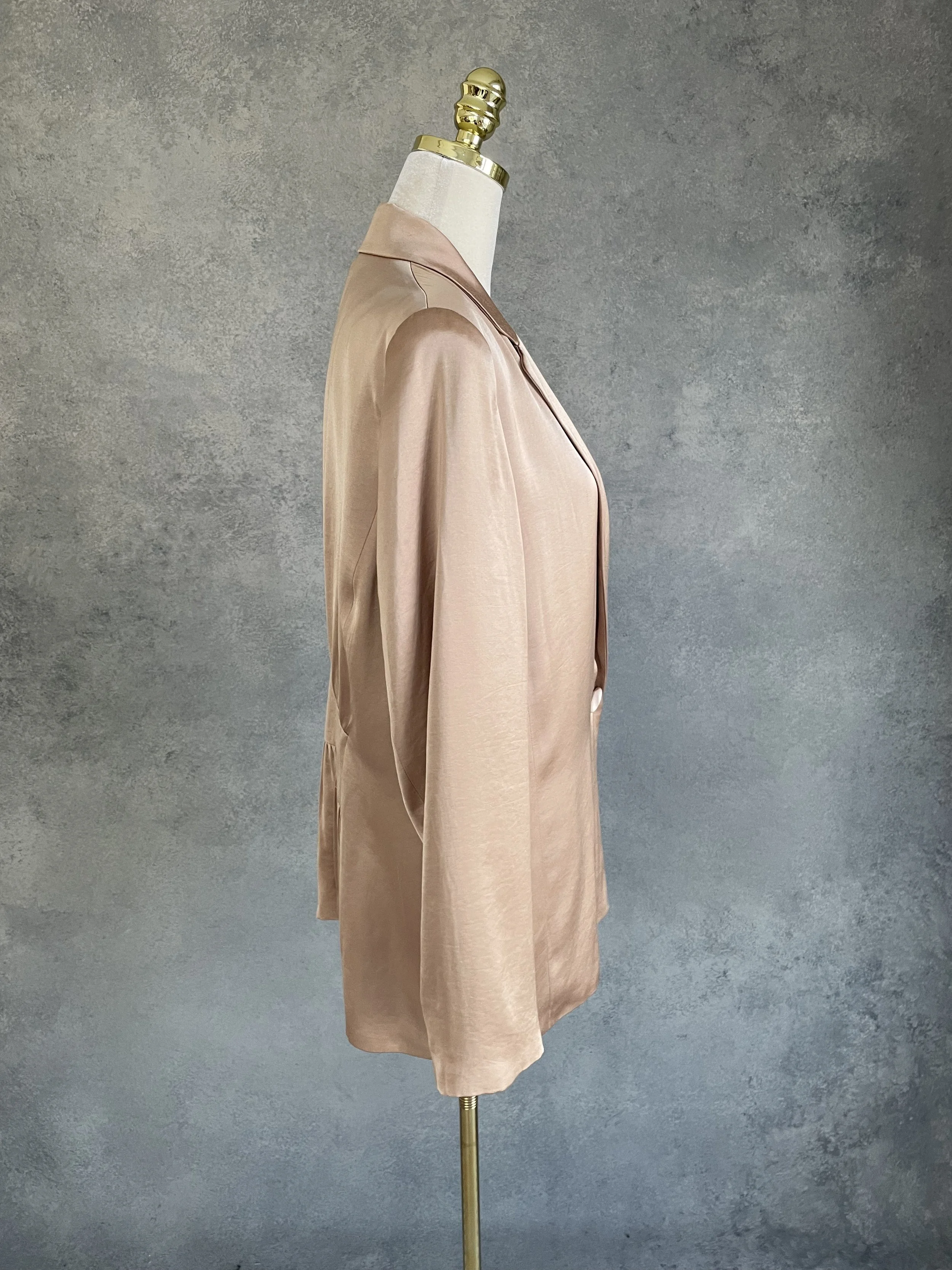 Side view of the golden blazer, showing the refined cut and silky texture.