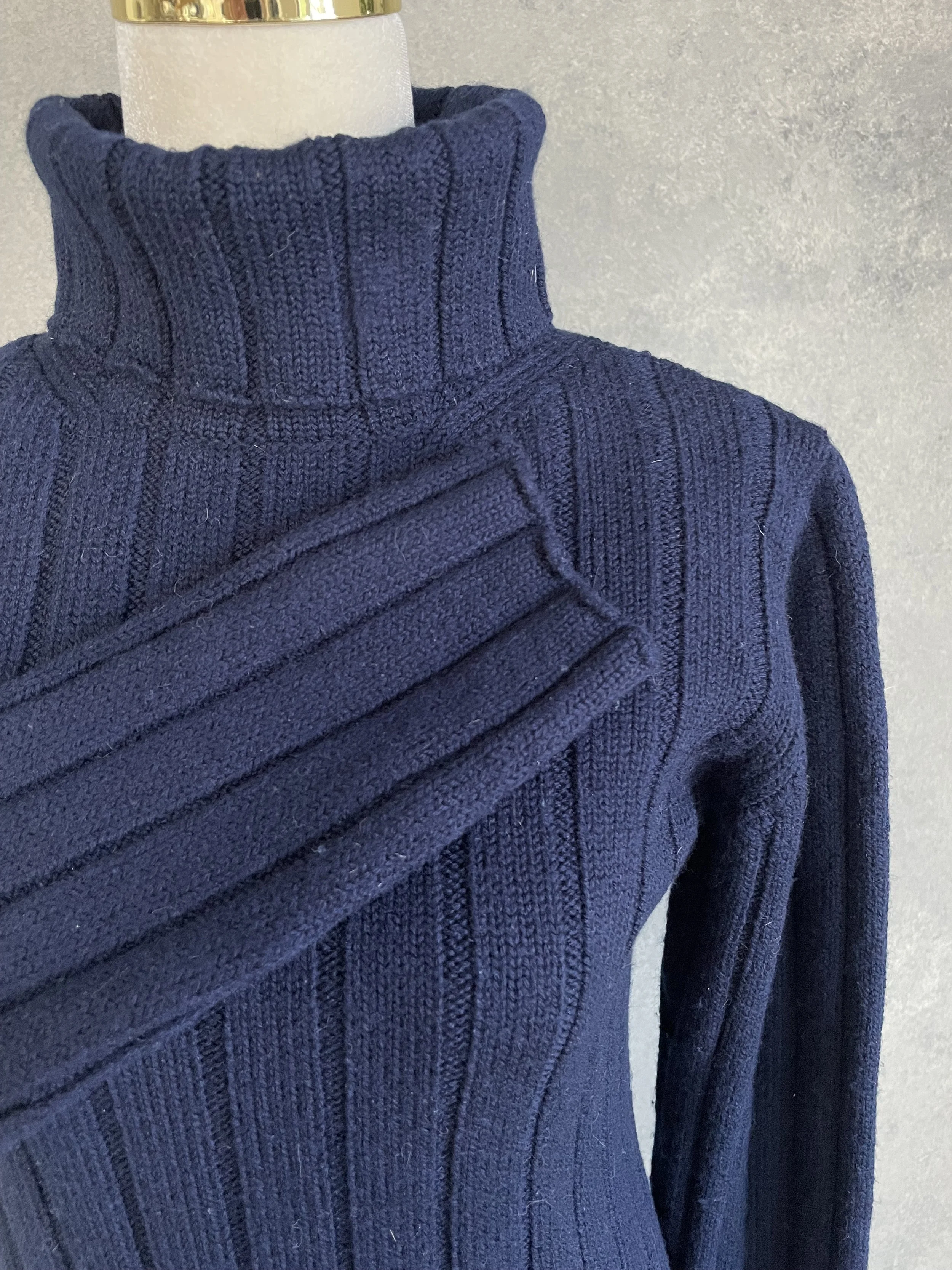 Close-up of the Hugo Boss navy turtleneck sleeve and ribbed cuff, emphasizing the quality of the wool knit.