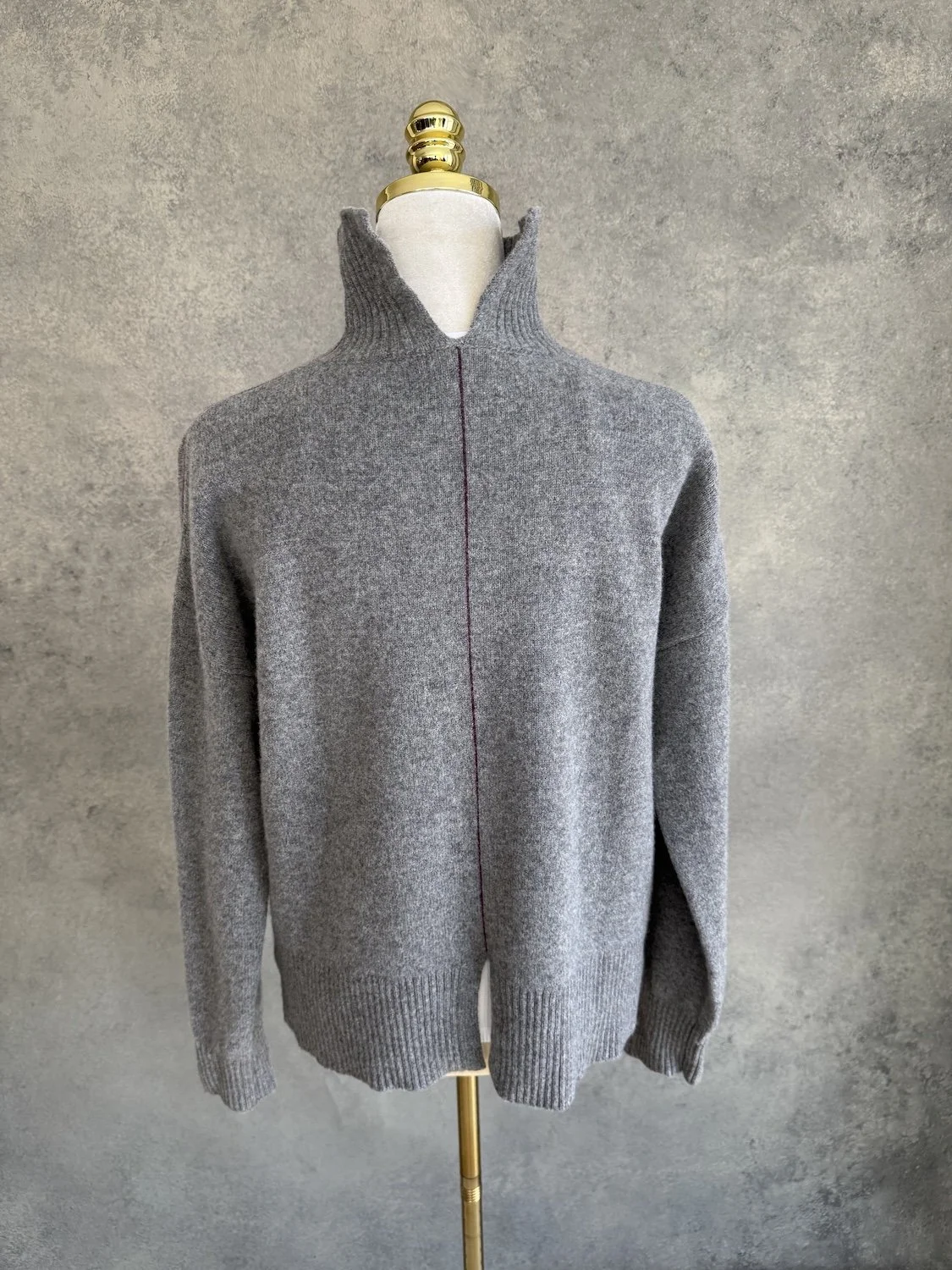 Back view of the grey knit sweater with the vertical seam line