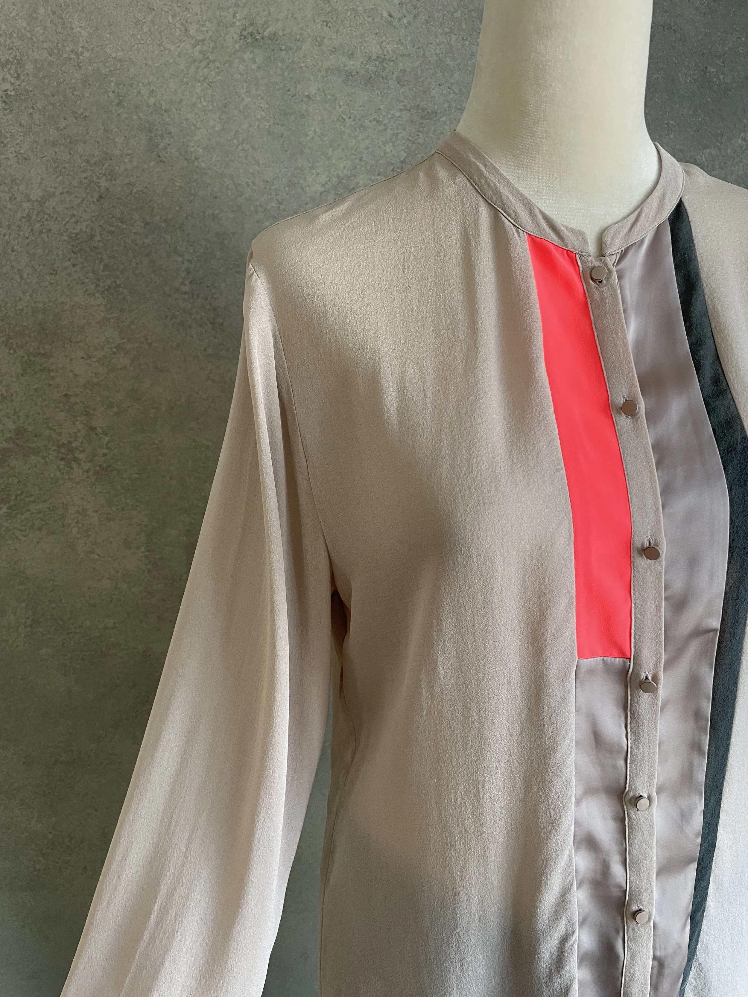 Close-up of the Custommade silk blouse sleeve, highlighting the soft drape of the fabric and refined tailoring