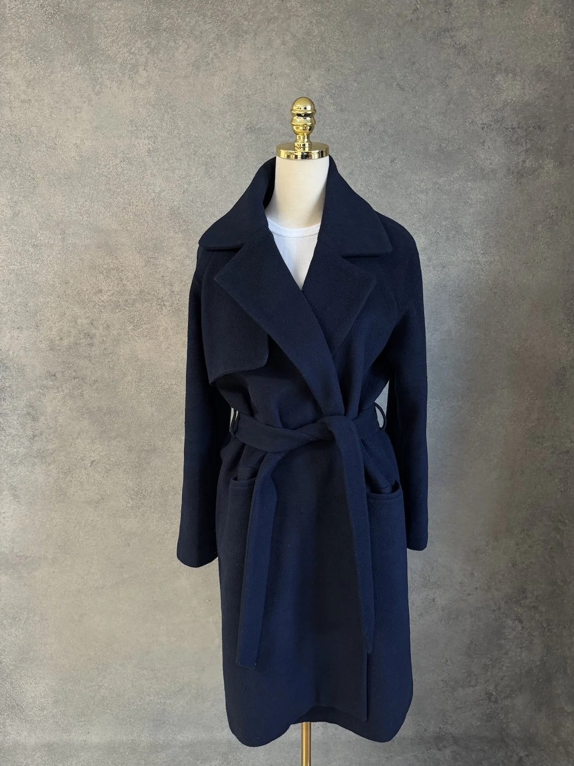 Front view of the dark navy blue 2NDDAY wool-blend wrap coat on a mannequin, showcasing the deep lapel collar, tie belt, and patch pockets.