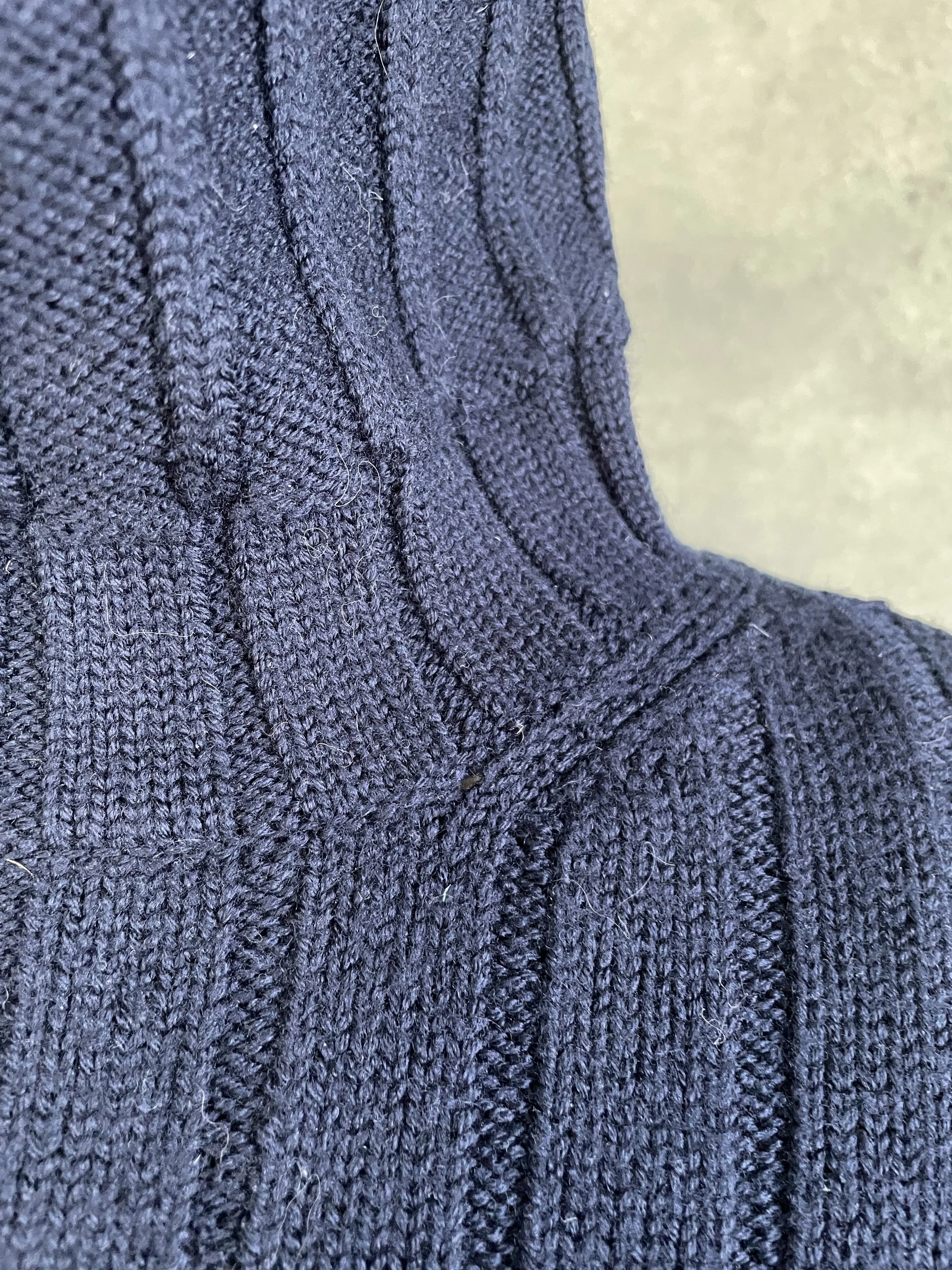 Close-up detail of the Hugo Boss turtleneck collar, showing the refined ribbed finish and premium construction.