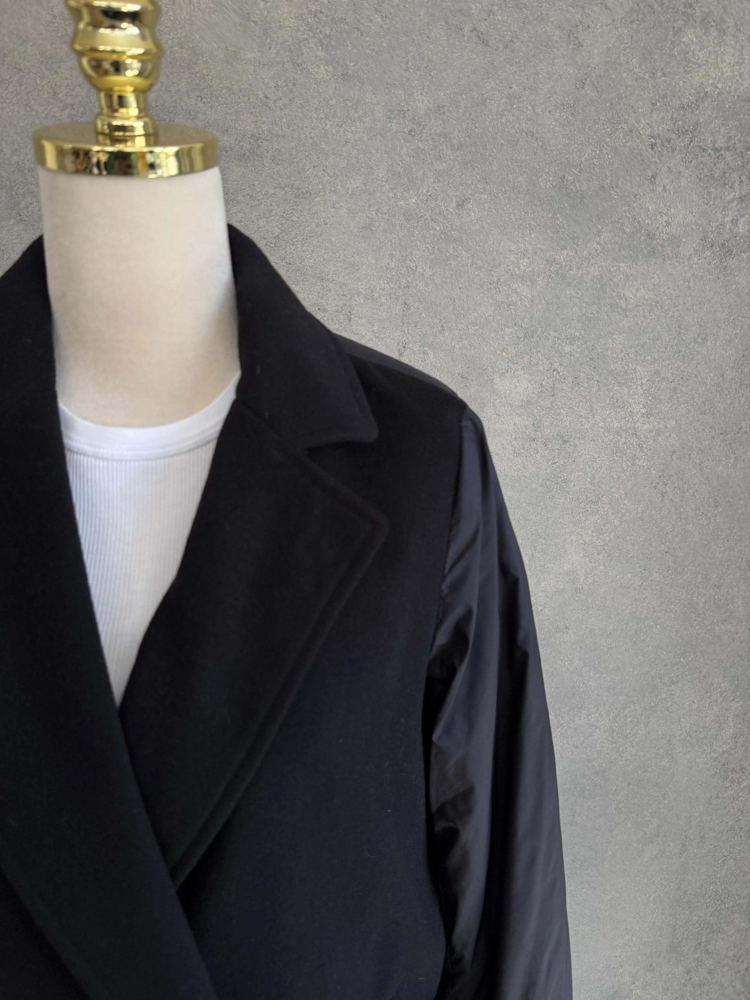 Detail view of the shoulder area showing the transition from the wool fabric to the nylon sleeve.