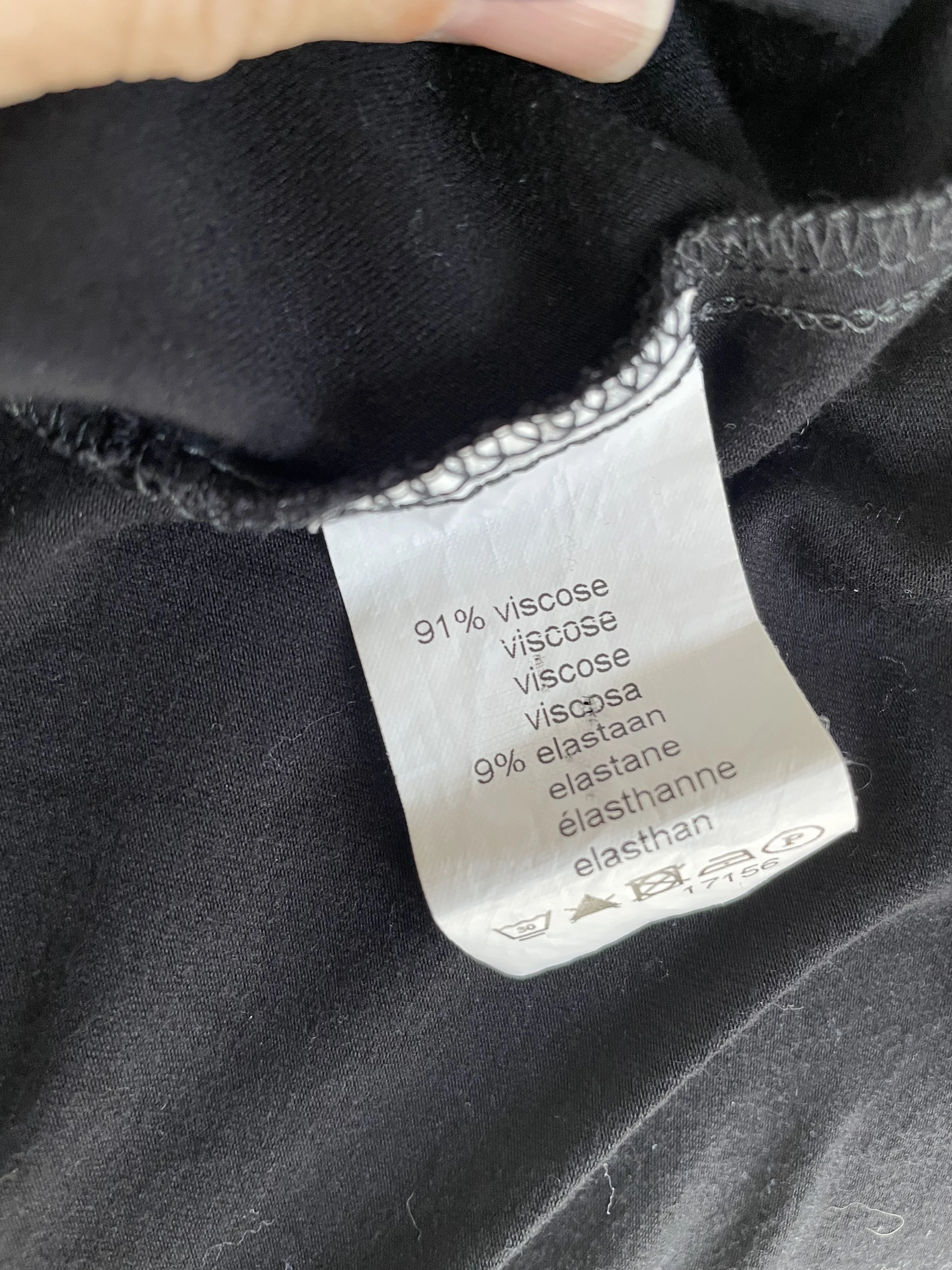 Detailed photo of the fabric composition and care label inside the Scapa dress, listing 91% viscose and 9% elastane