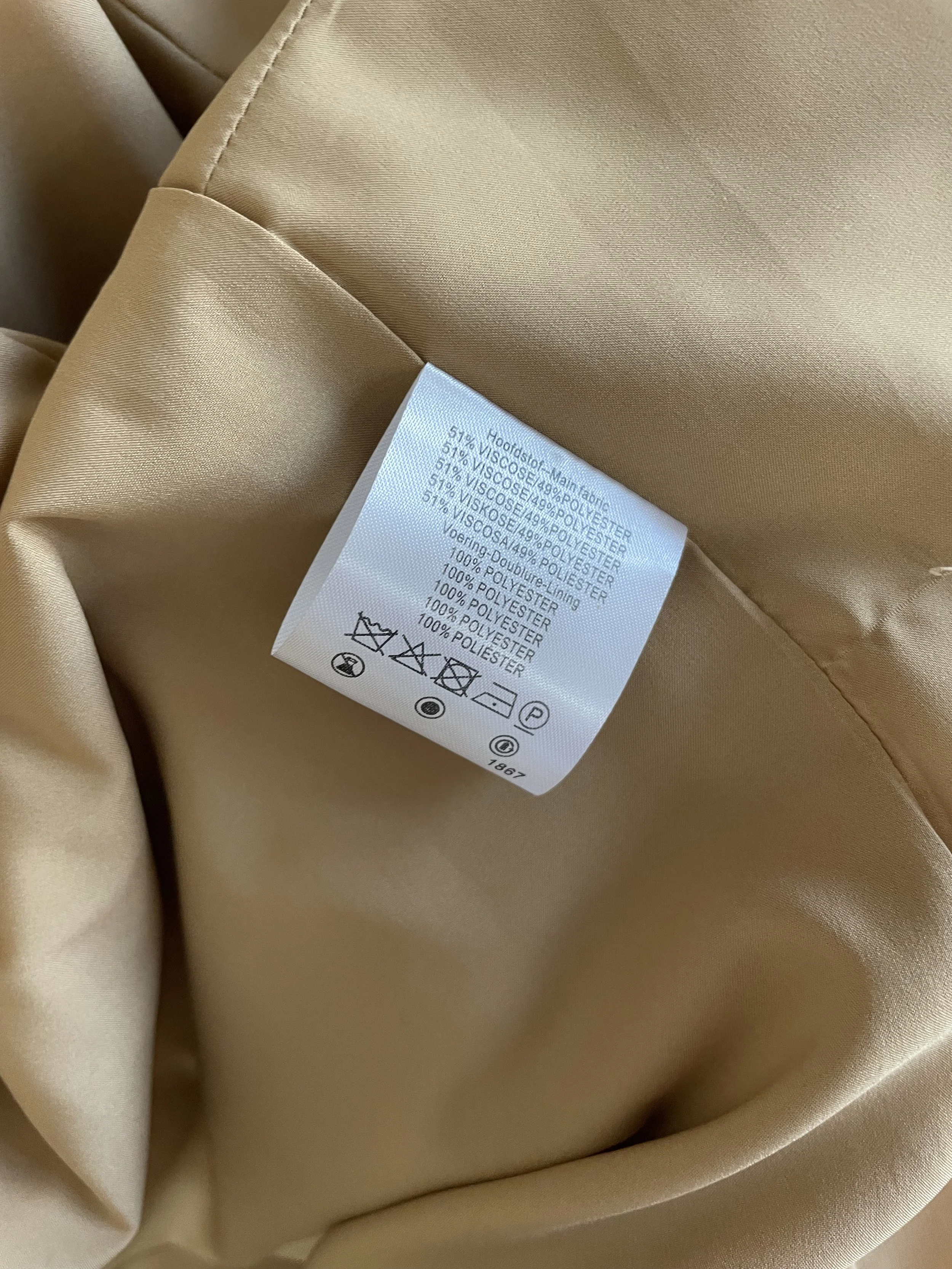 Close-up of the care label detailing the viscose and polyester fabric composition.