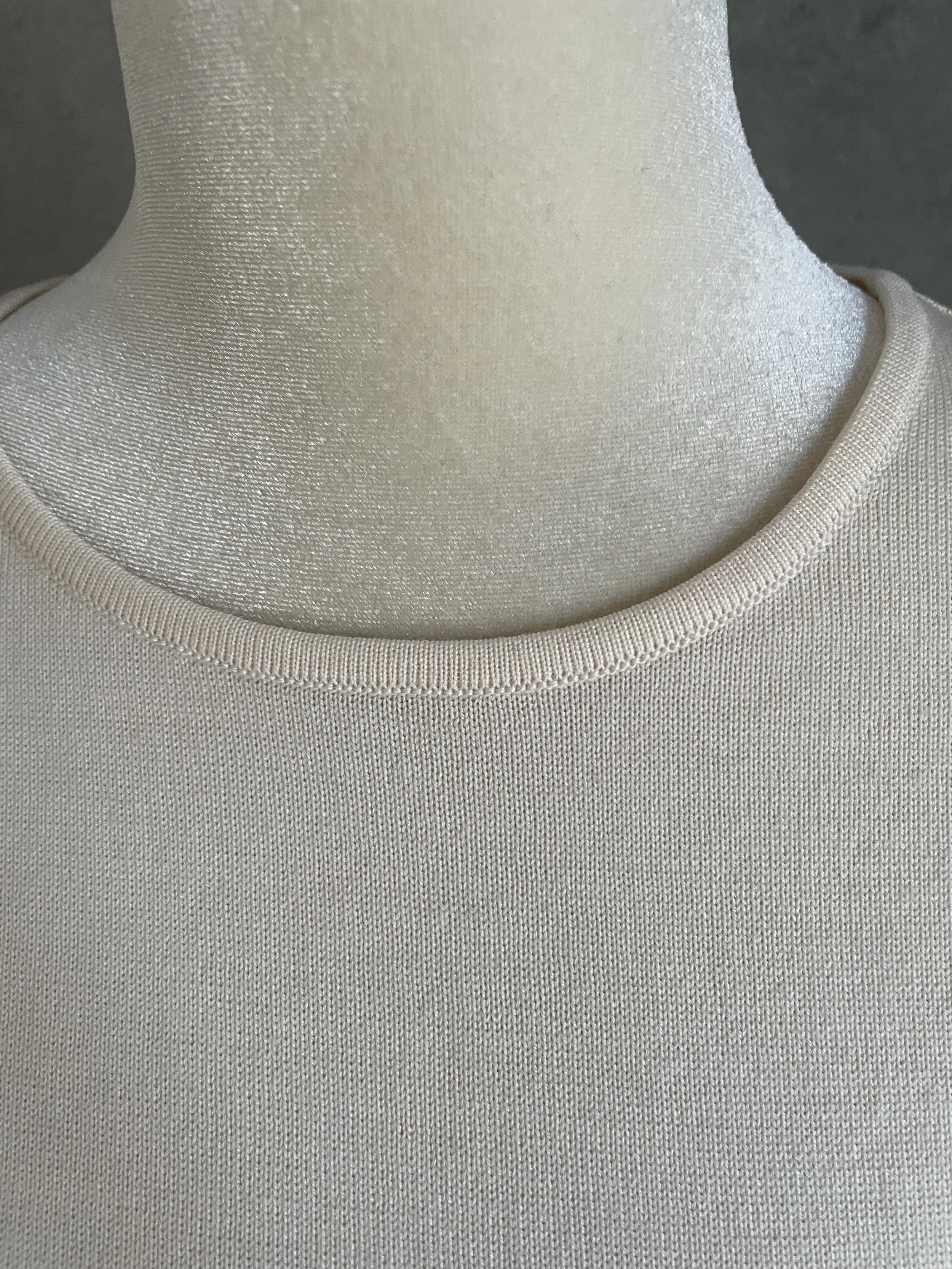 Close-up detail of the Escada top’s refined, high-quality neckline, demonstrating the professional knit finish."