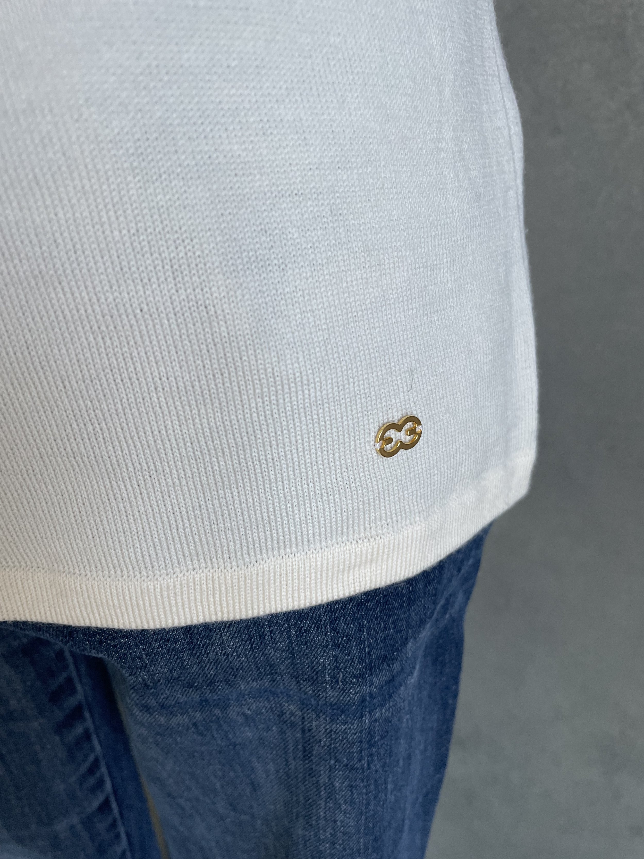 "Detail view of the Escada wool top's bottom hem, showing the precise edge stitching and clean aesthetic."
