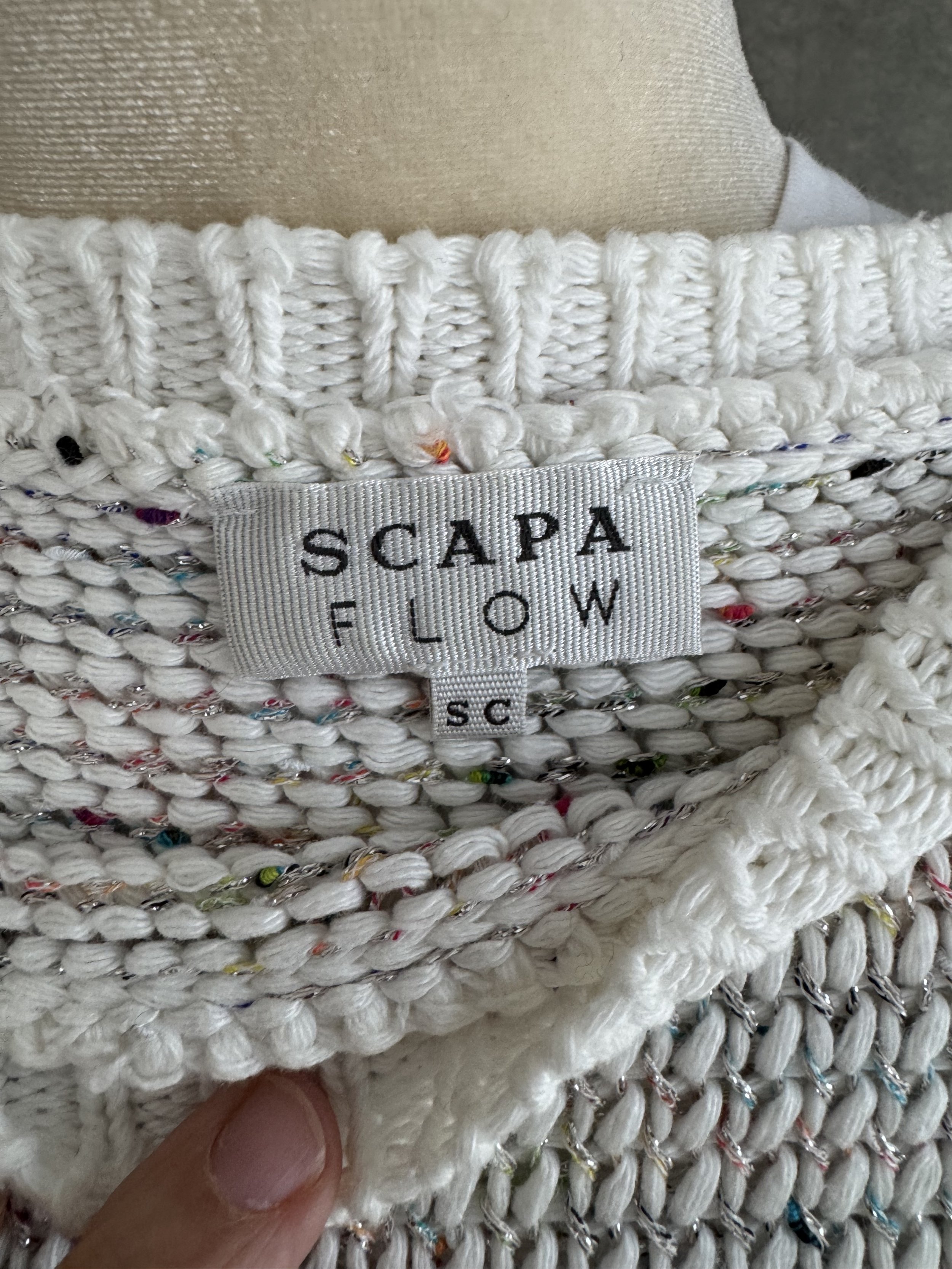 Close-up of the interior collar label reading 'SCAPA FLOW SC' in black embroidery on a white background.