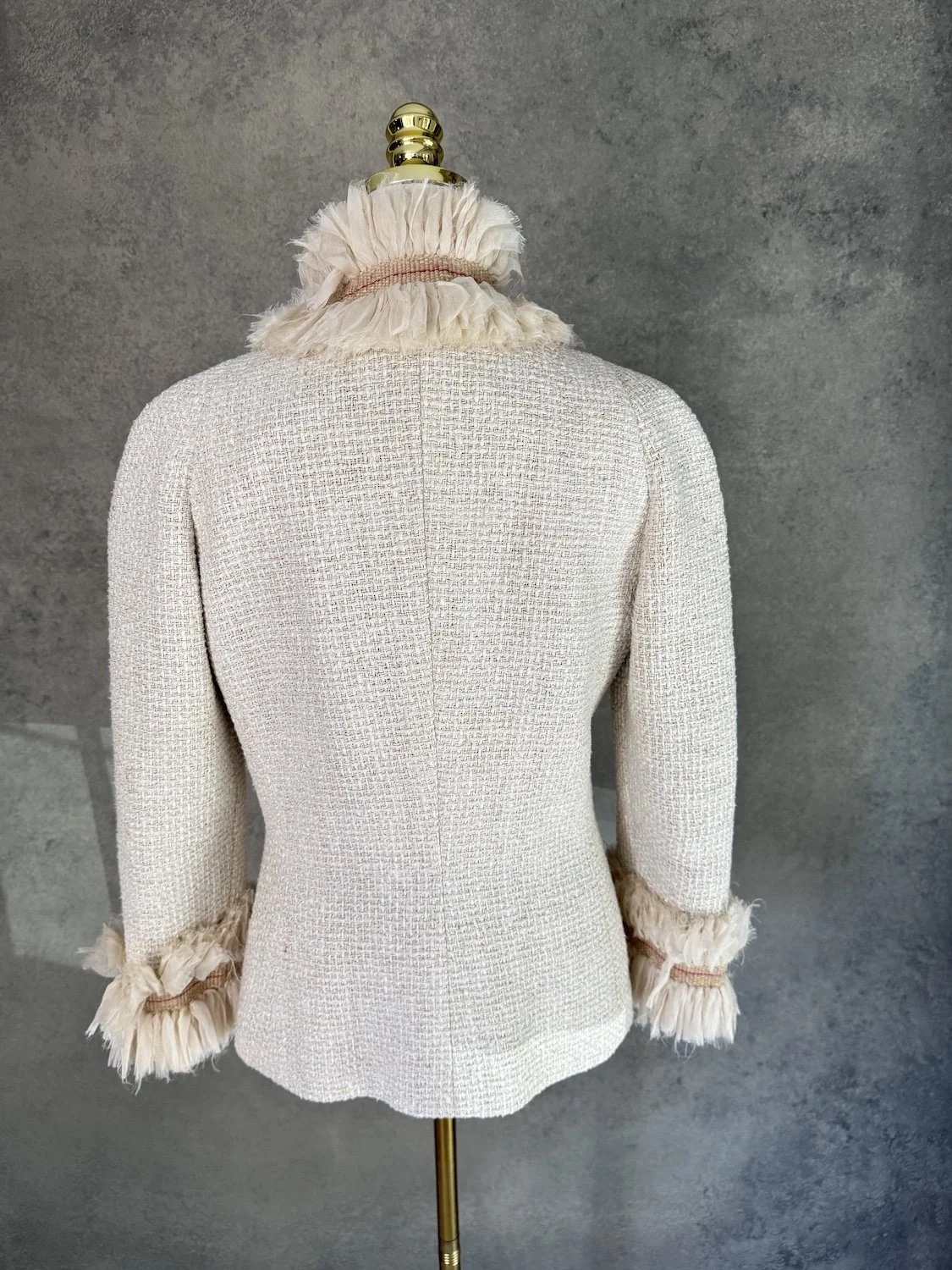 Back view of Jantaminiau beige tweed blazer with high ruffle collar