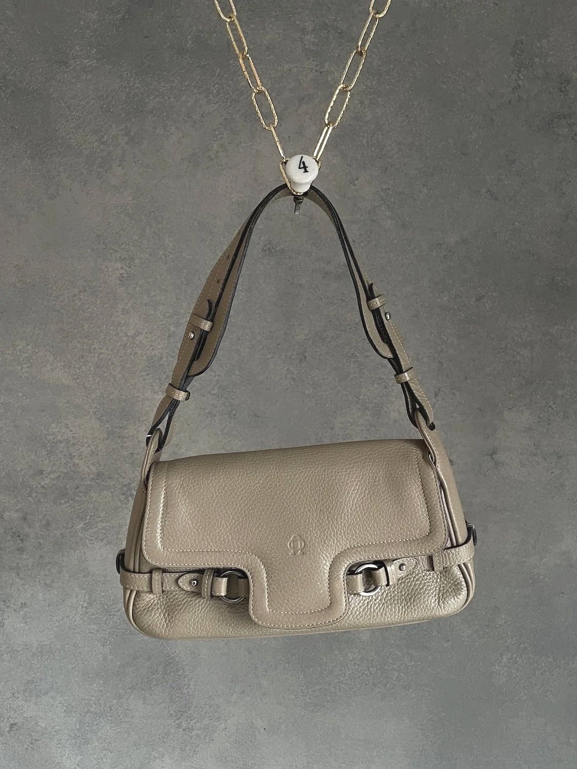 leather Nobody baguette bag suspended by a gold chain