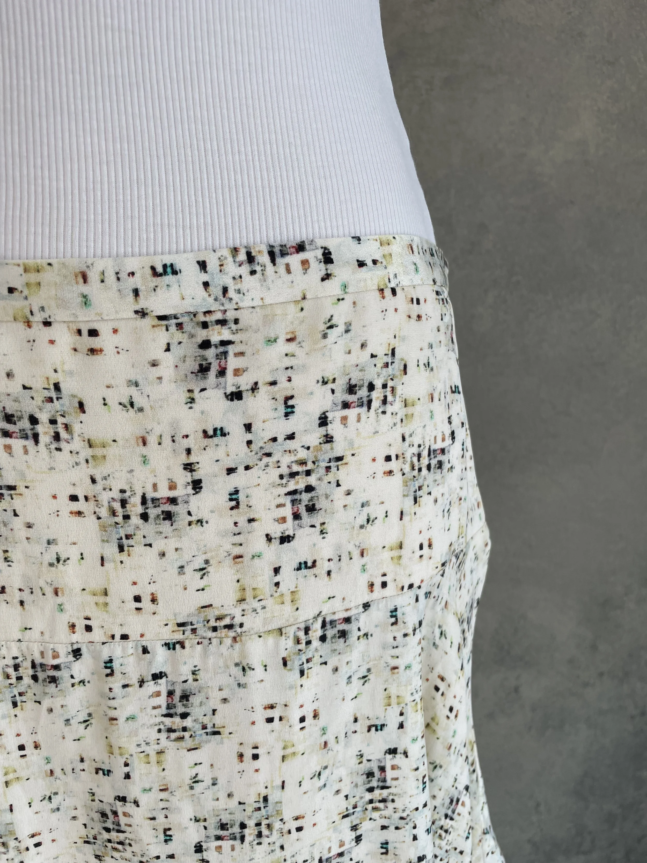 Detailed view of the fabric texture of a Joseph abstract print mini skirt.