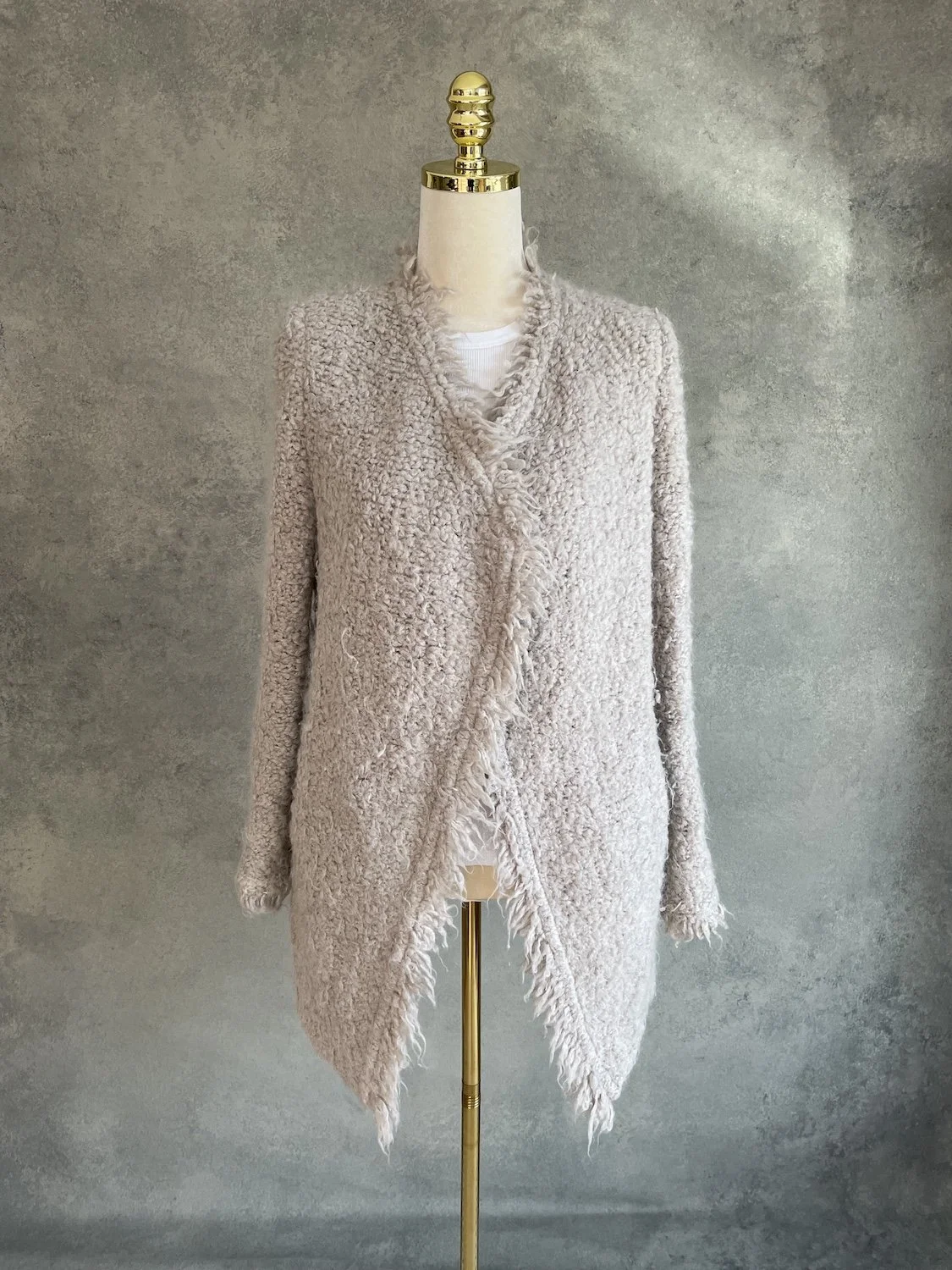 Front-closed view of the IRO textured wool blazer on a mannequin, highlighting the asymmetric front drape and fluffy bouclé finish.