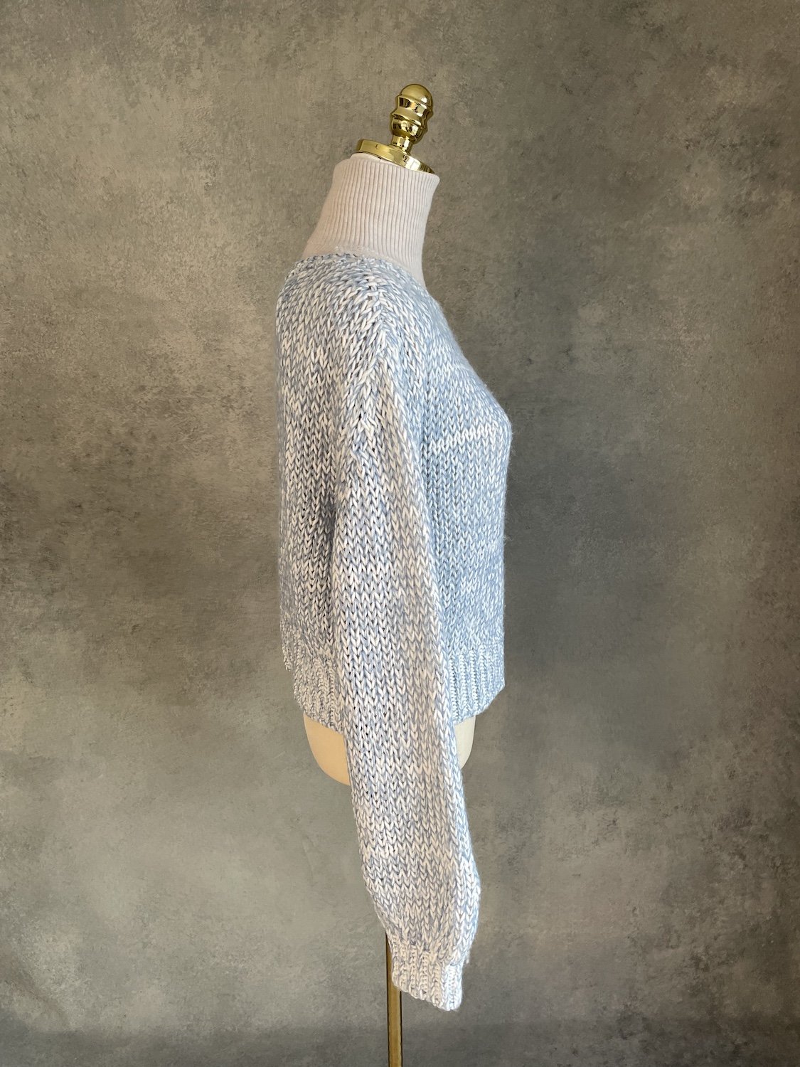 Side profile view of the Scapa Flow chunky knit sweater showing the relaxed sleeve shape and cropped silhouette.
