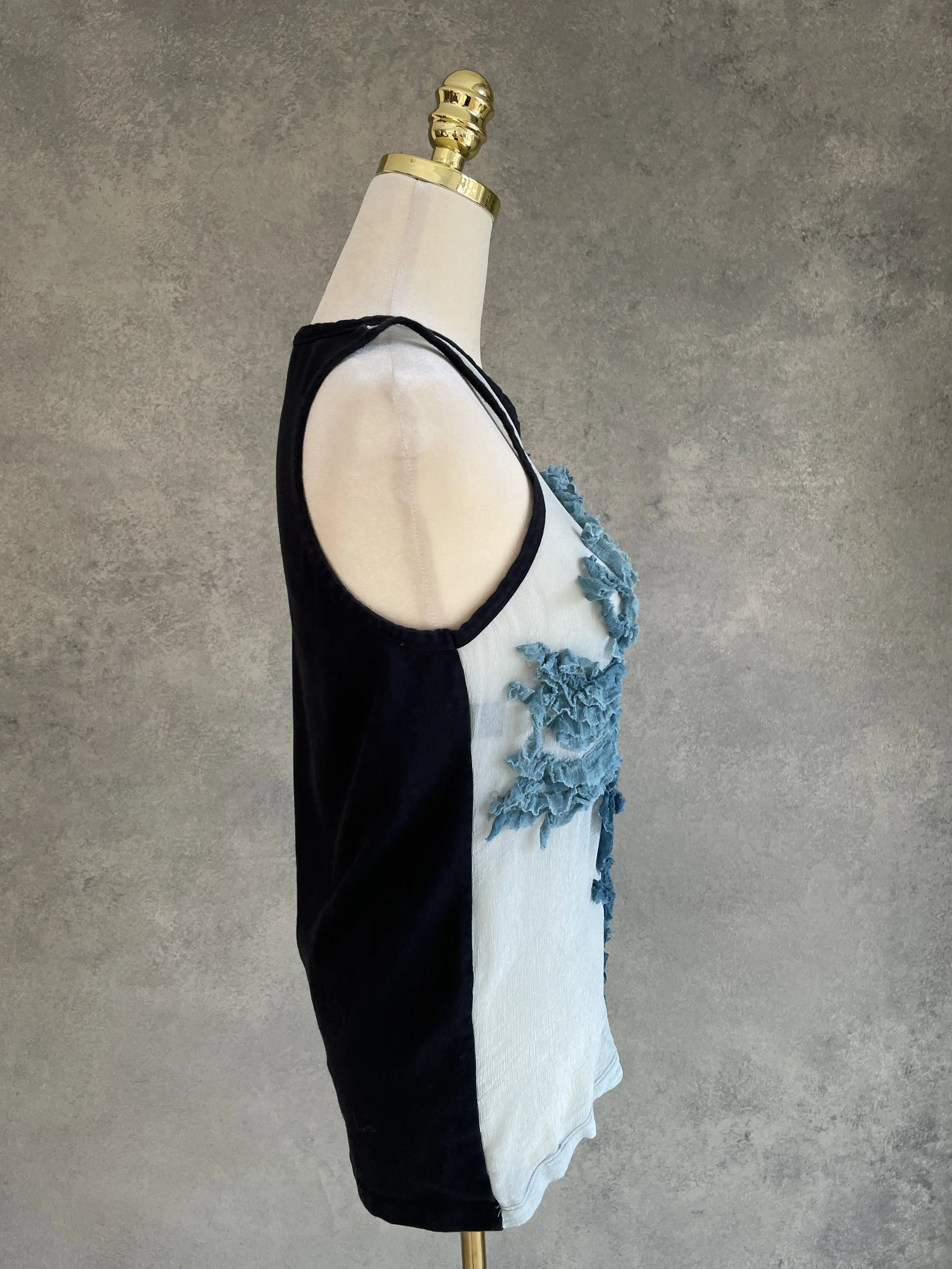 Side profile view showcasing the side zipper detail and the transition between black jersey and blue sheer fabric.