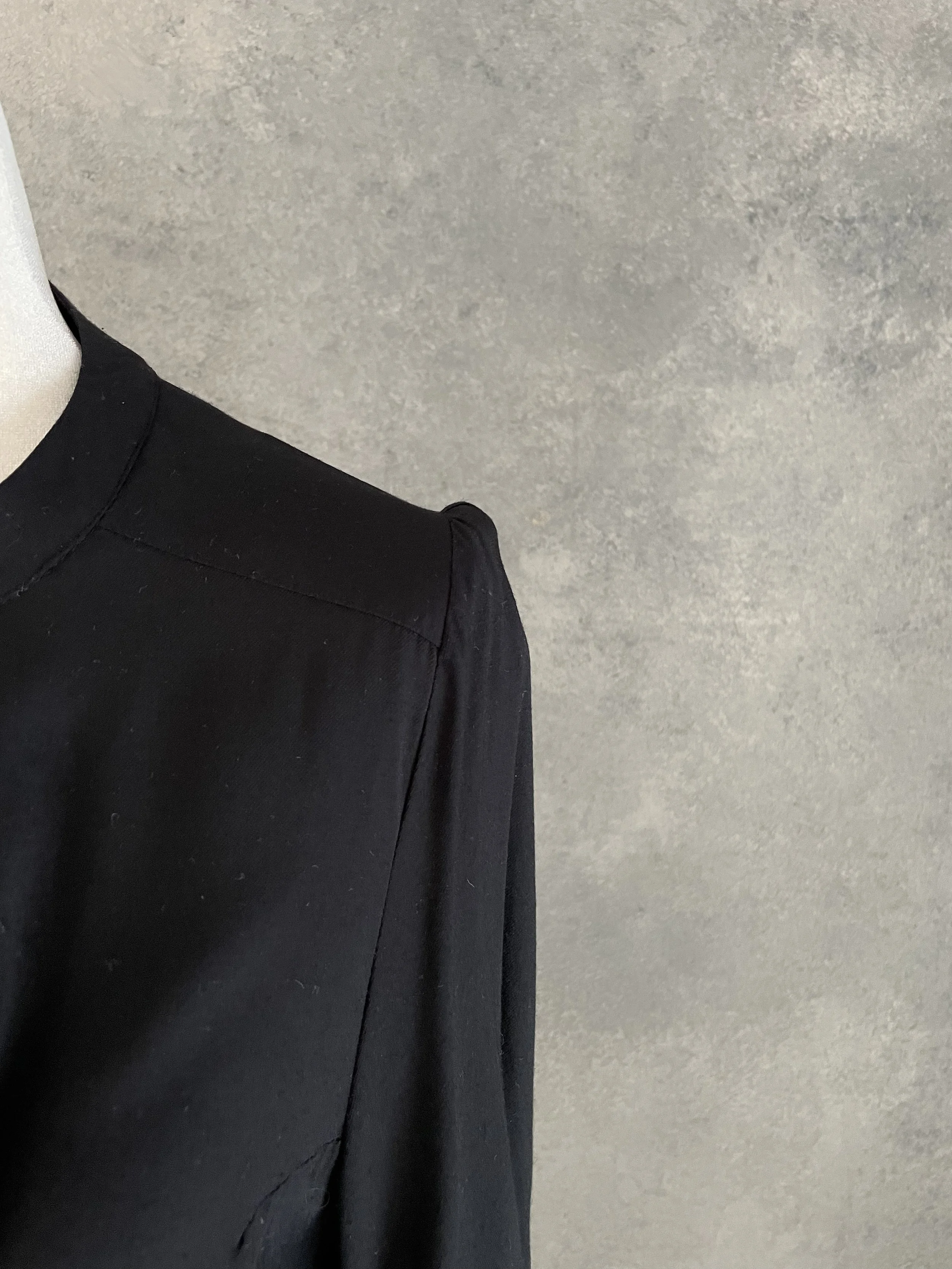Close-up of the subtle gathered shoulder detail on the black Rodebjer Lucy blouse.
