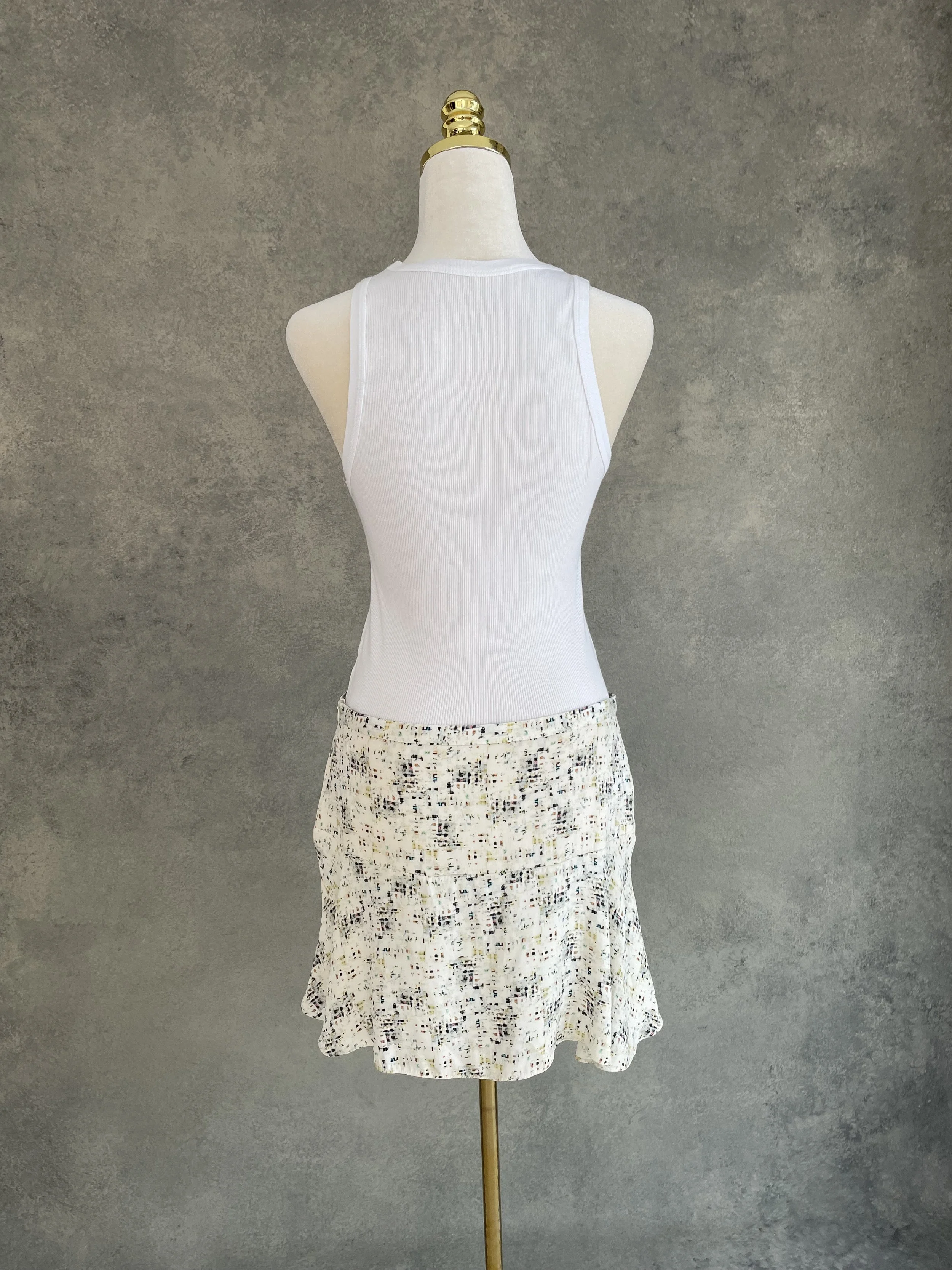 Back view of a Joseph abstract print mini skirt on a mannequin.