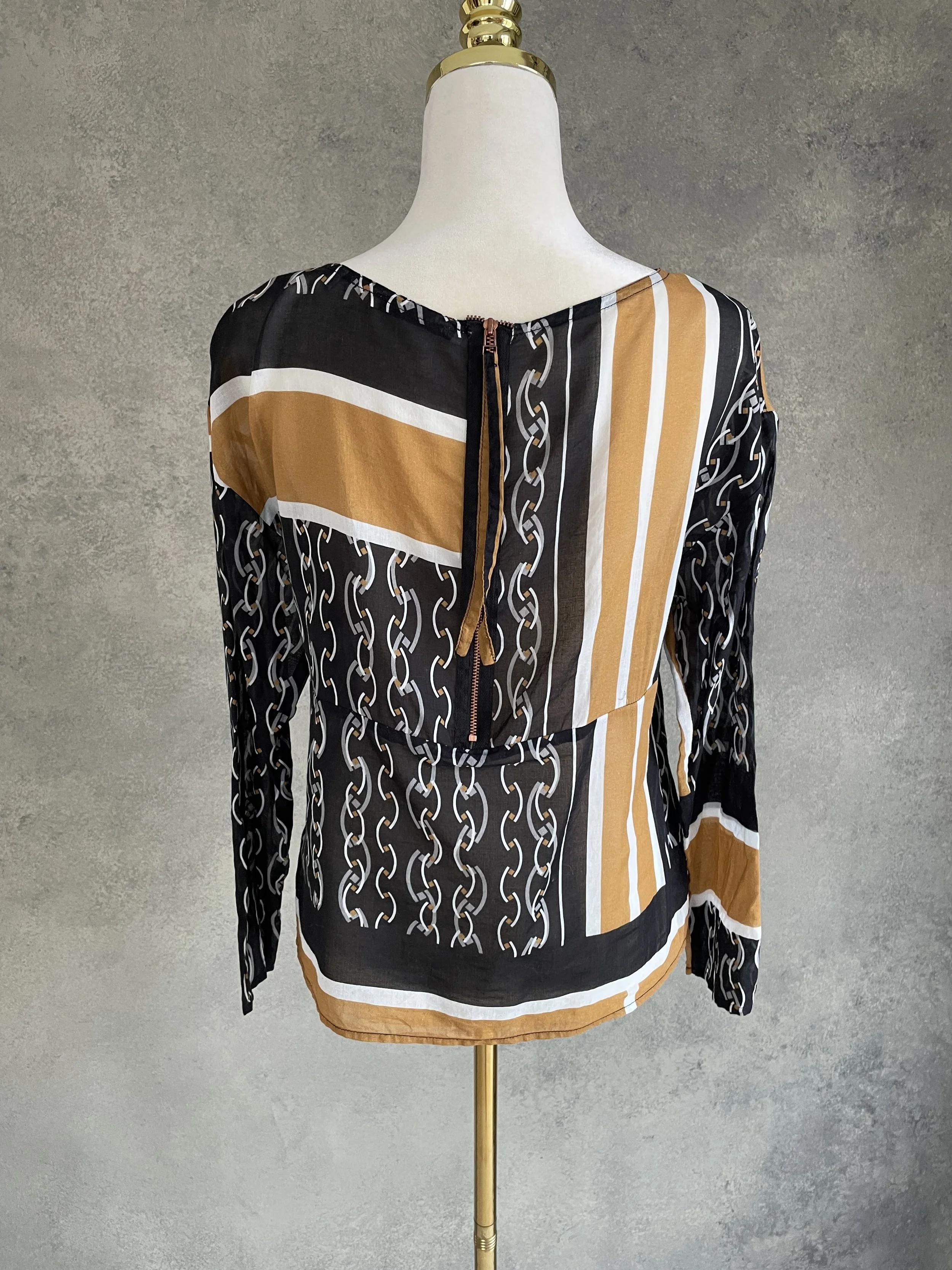 Back view of the HOPE blouse showing the metallic full-length zipper detail.