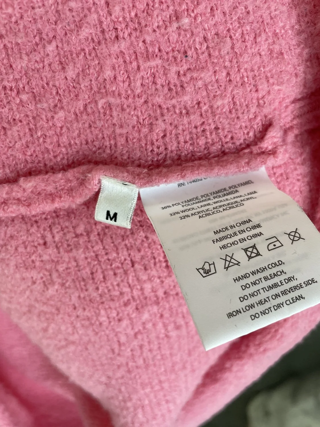 Essentiel Antwerp material and care composition tag showing wool polyamide acrylic mix and hand wash instructions