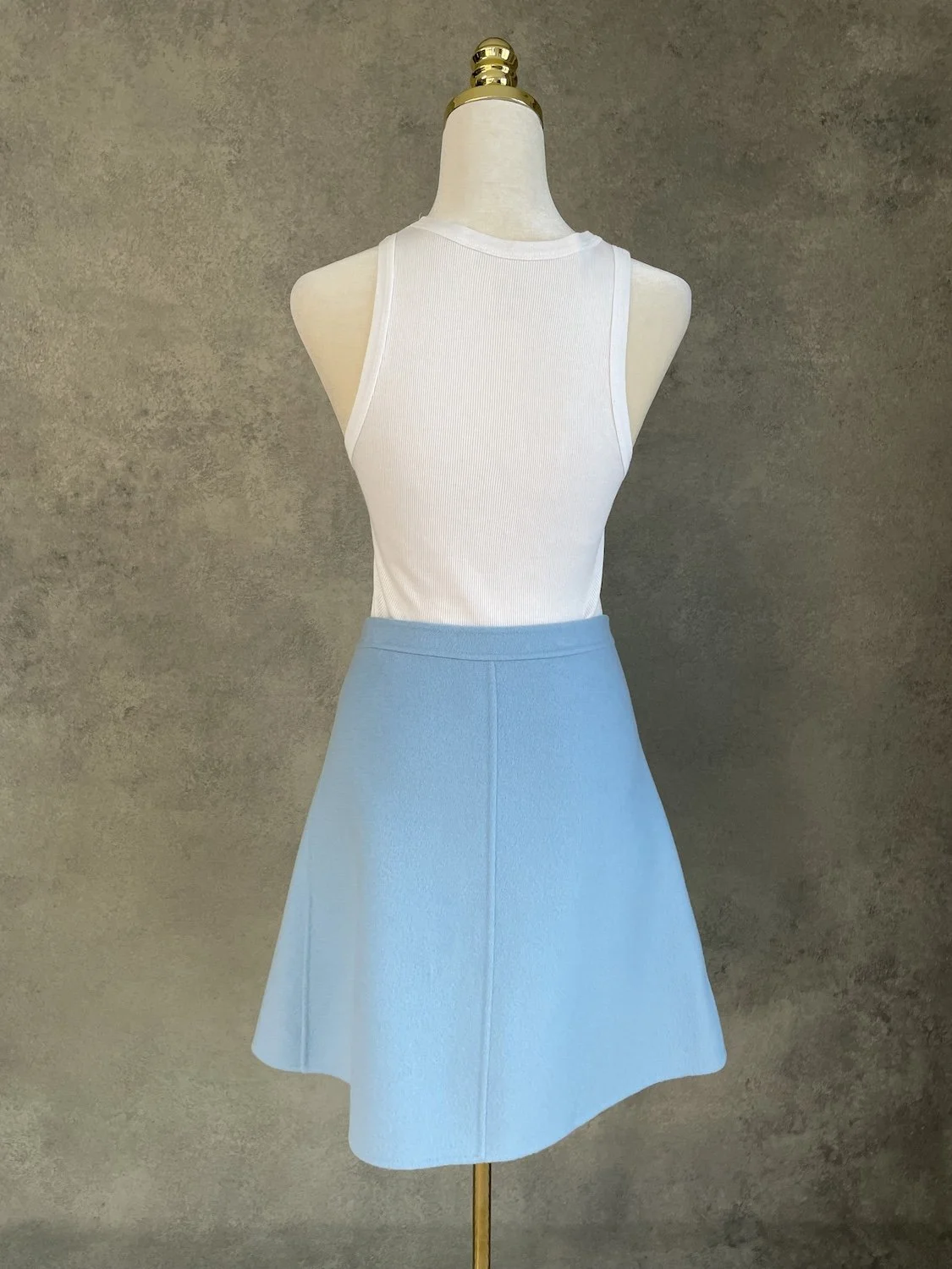 Full back view of the light blue A-line cashmere skirt with center vertical seam detail