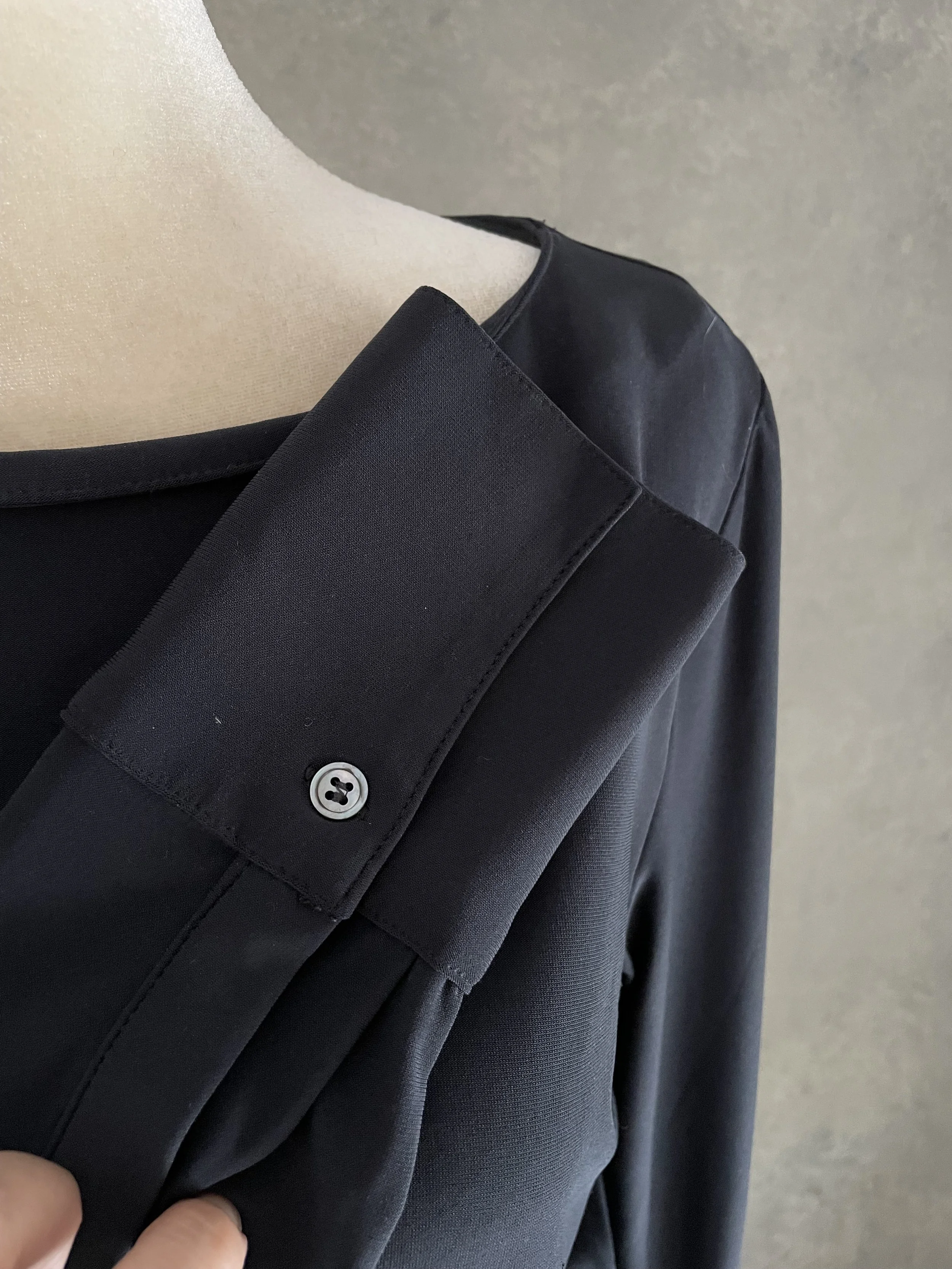 Close-up detail of the high-quality sleeve cuffs and button design on the Rue Blanche dress.