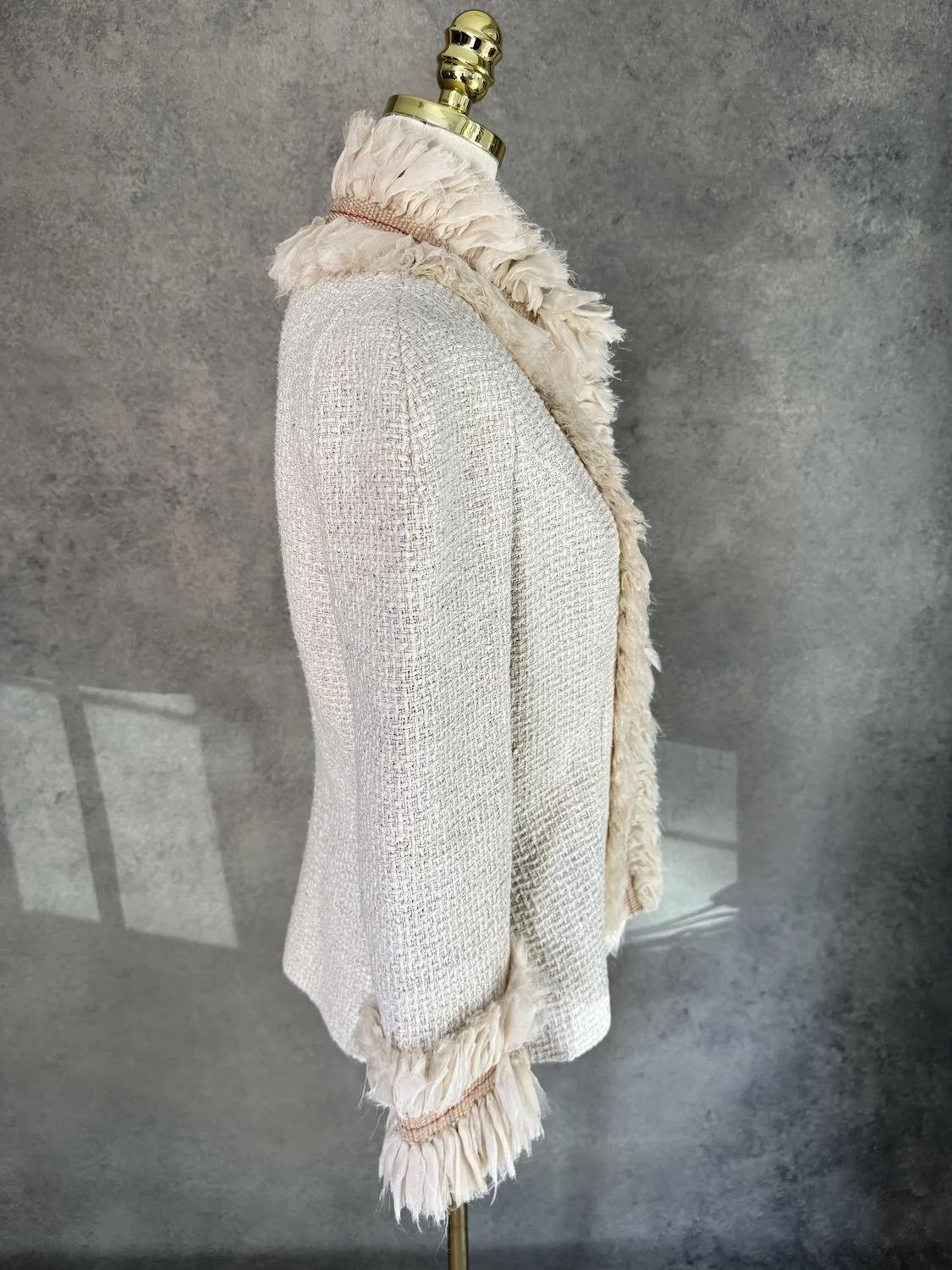 Side profile view of Jantaminiau structured tweed ruffle blazer