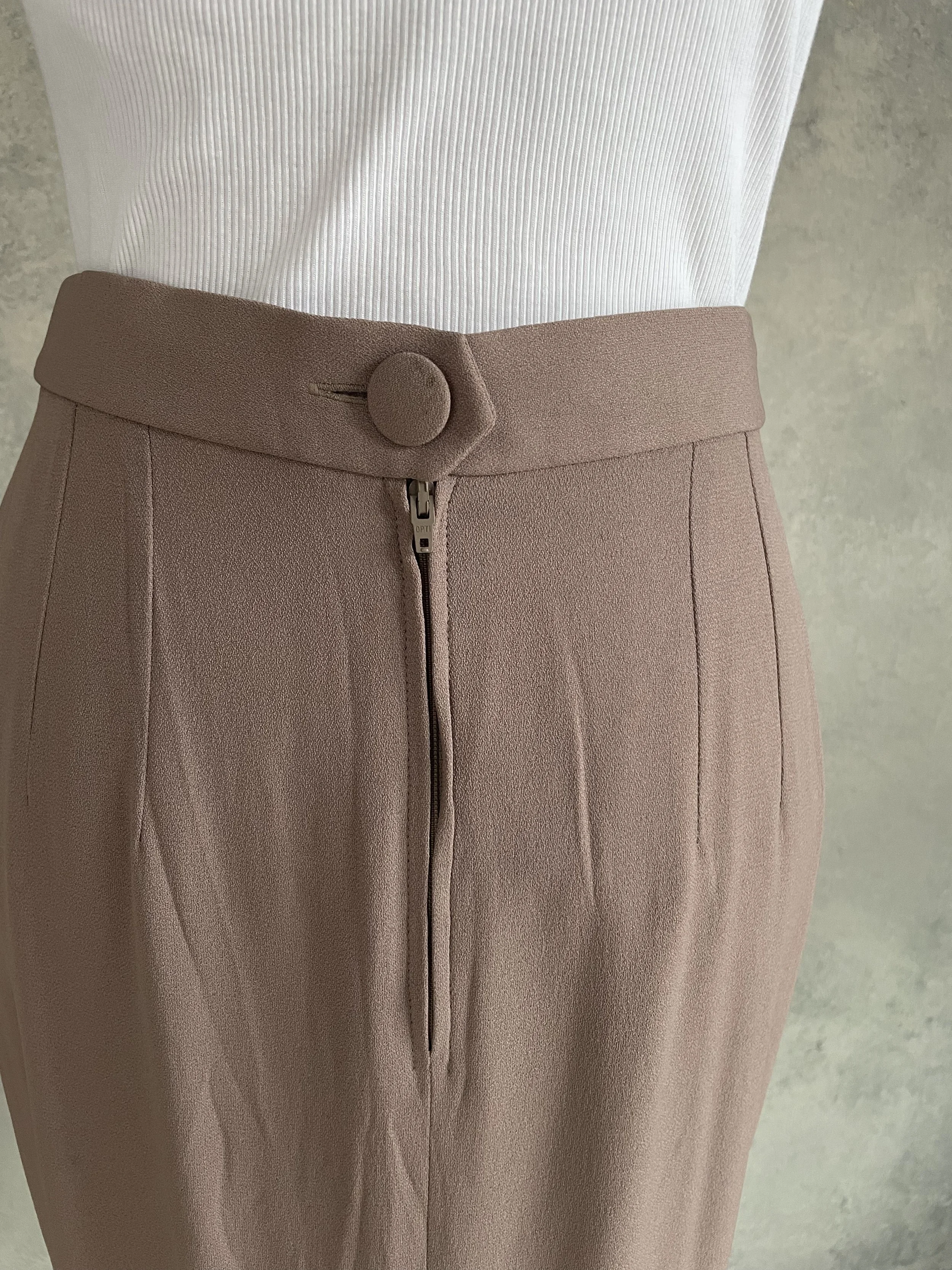 Detailed shot of the skirt's fabric weave and sheen, Natan luxury fashion.